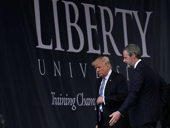 Accompanied by President Jerry Falwell (R), U.S. President Donald Trump (L) leaves after he delivered keynote address during the commencement at Liberty University May 13, 2017 in Lynchburg, Virginia. (Alex Wong—Getty Images)