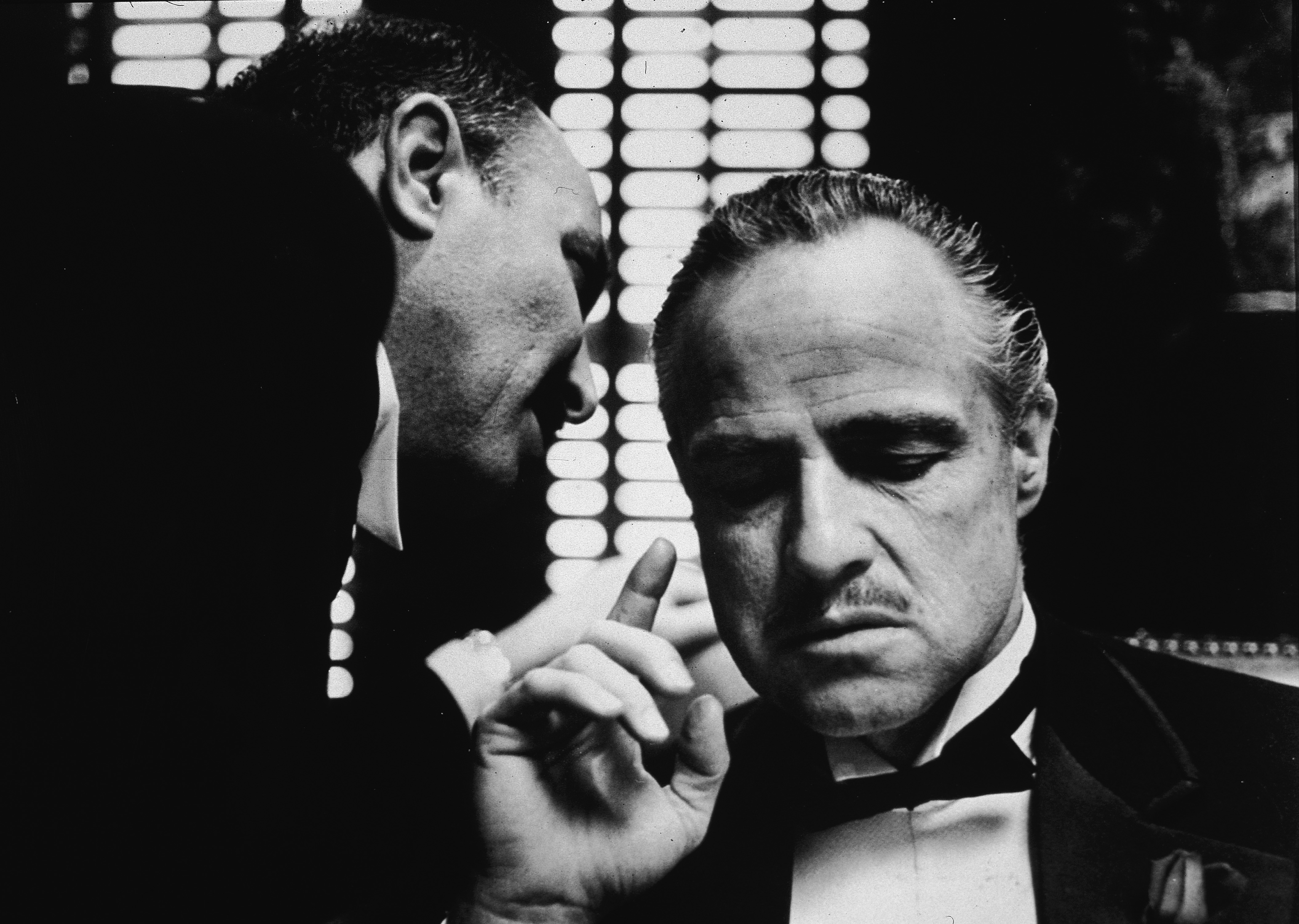 American actor Marlon Brando listens as an unidentified actor speaks close to one ear in a still from the film, 'The Godfather,' directed by Francis Coppola, 1972 (Paramount Pictures&mdash;Getty Images)