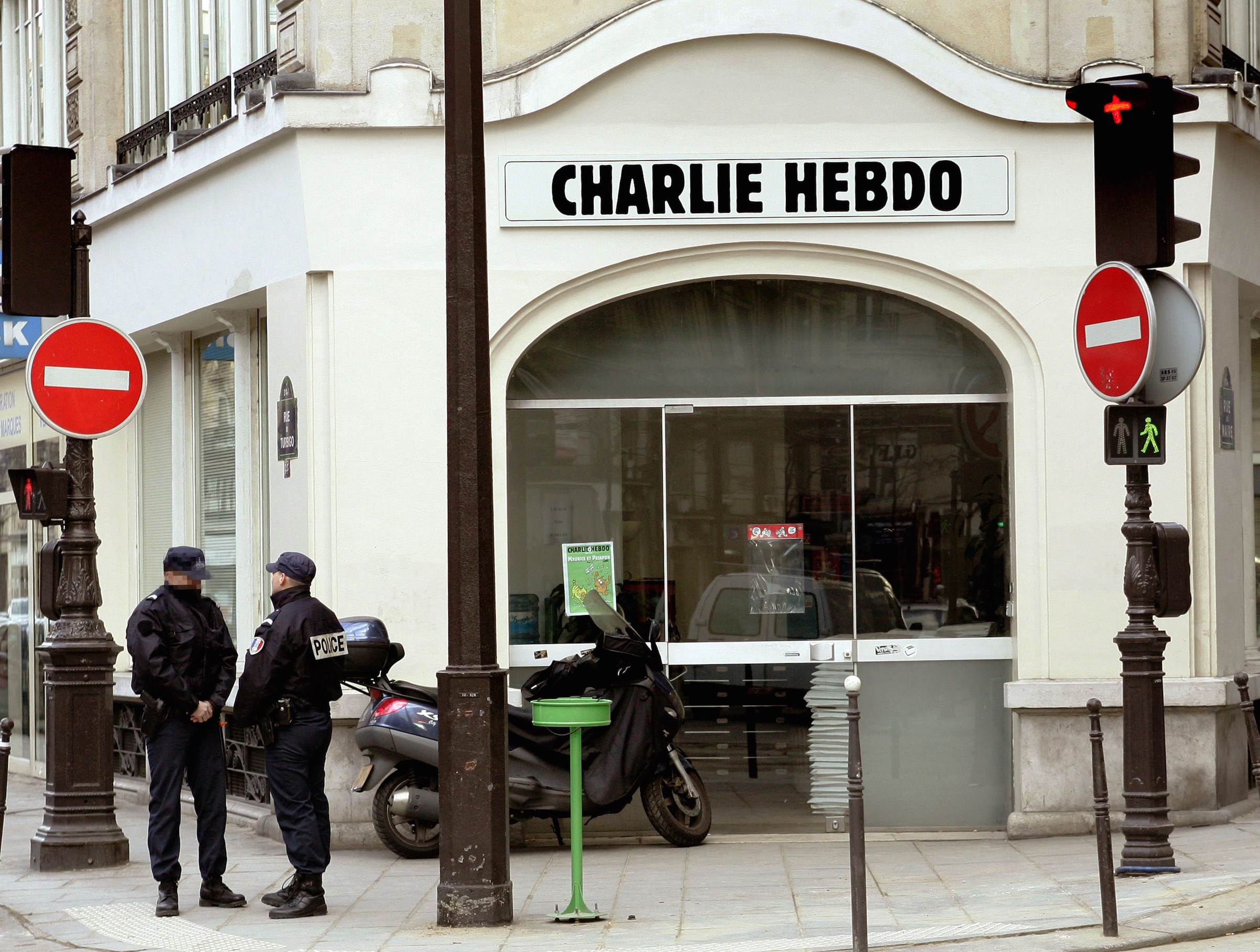 Policeman stand in front of the satirical French weekly Charlie Hebdo's headquarters, on Feb. 8, 2006, in Paris. (Pierre Verdy—AFP/Getty Images)