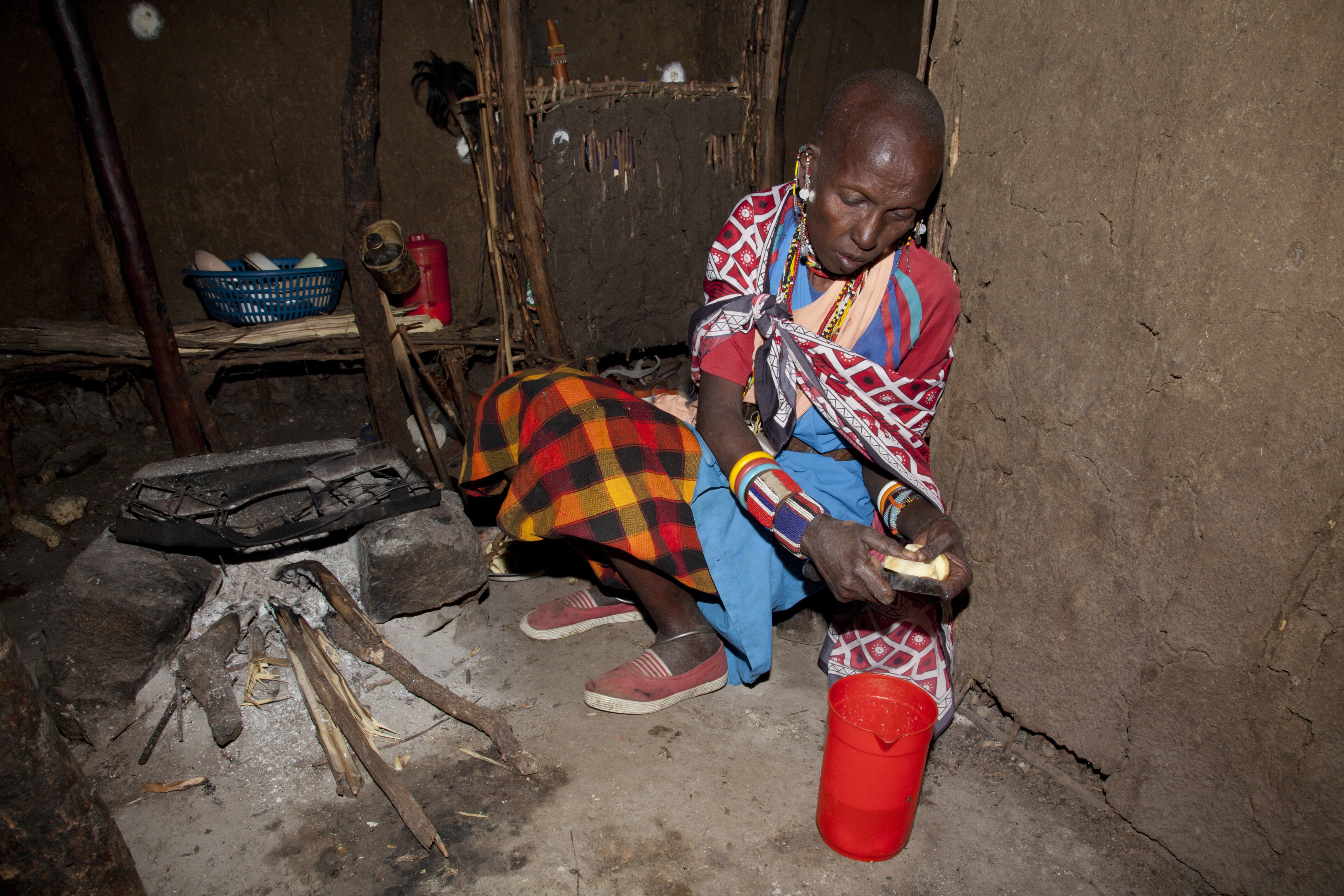 Masai wife of elder chief cooking in her hut in the village of Oliolomutia , next to the Masai Mara Nature Reserve, Kenya