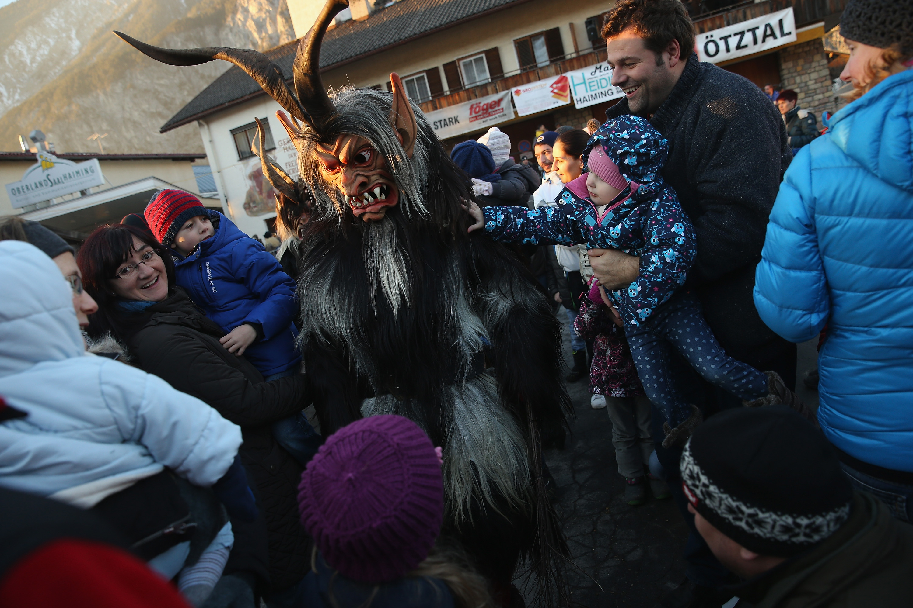 A member of the Haiminger Krampusgruppe dressed as the Krampus creature, an Austrian winter solstice ritual, lets himself be touched by onlookers prior to the annual Krampus night in Tyrol on Dec. 1, 2013. (Sean Gallup—Getty Images)