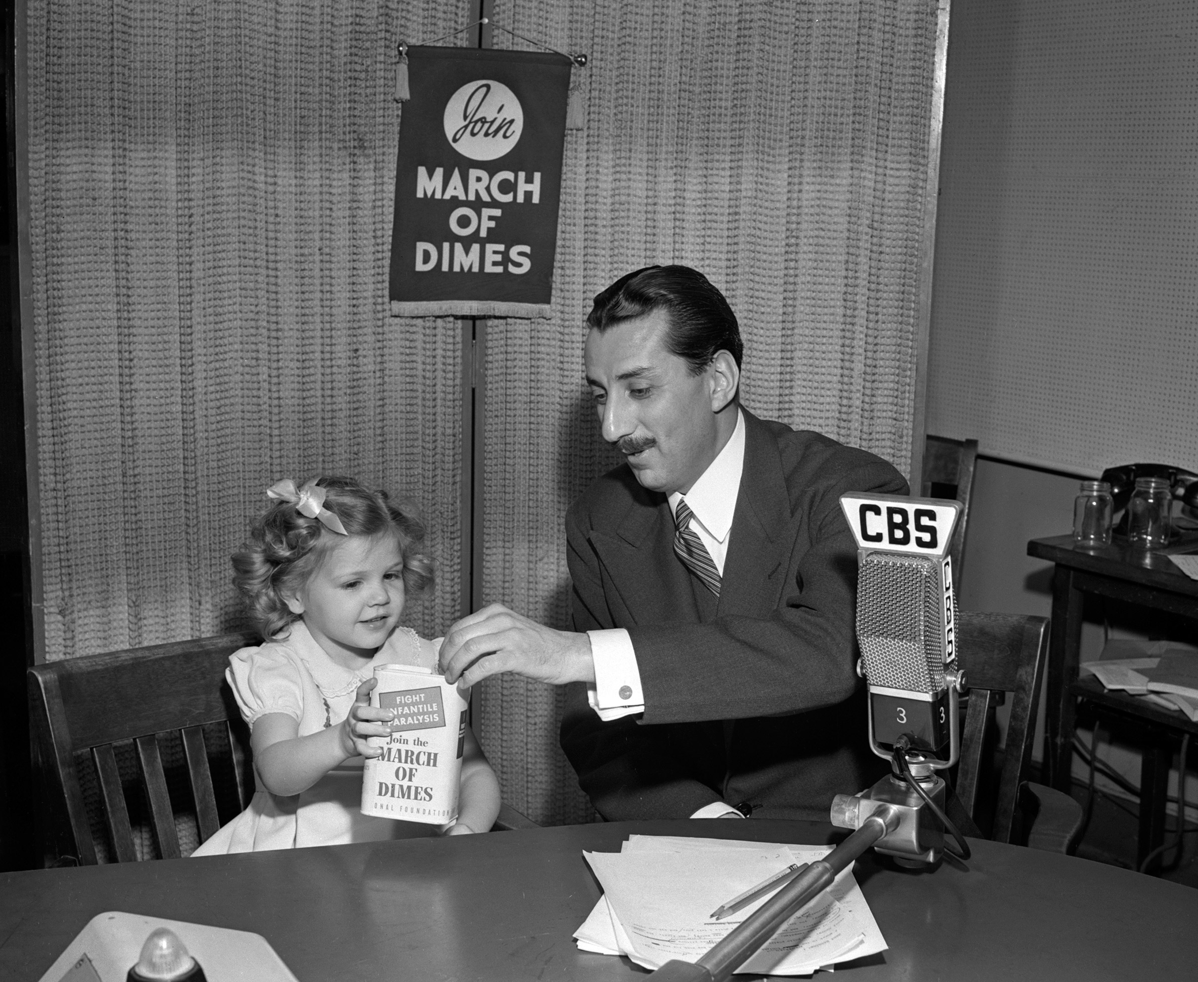 CBS Newsman Robert Trout with Nancy Drury, polio survivor and poster child for the March of Dimes on January 15, 1947. (CBS—Getty Images)