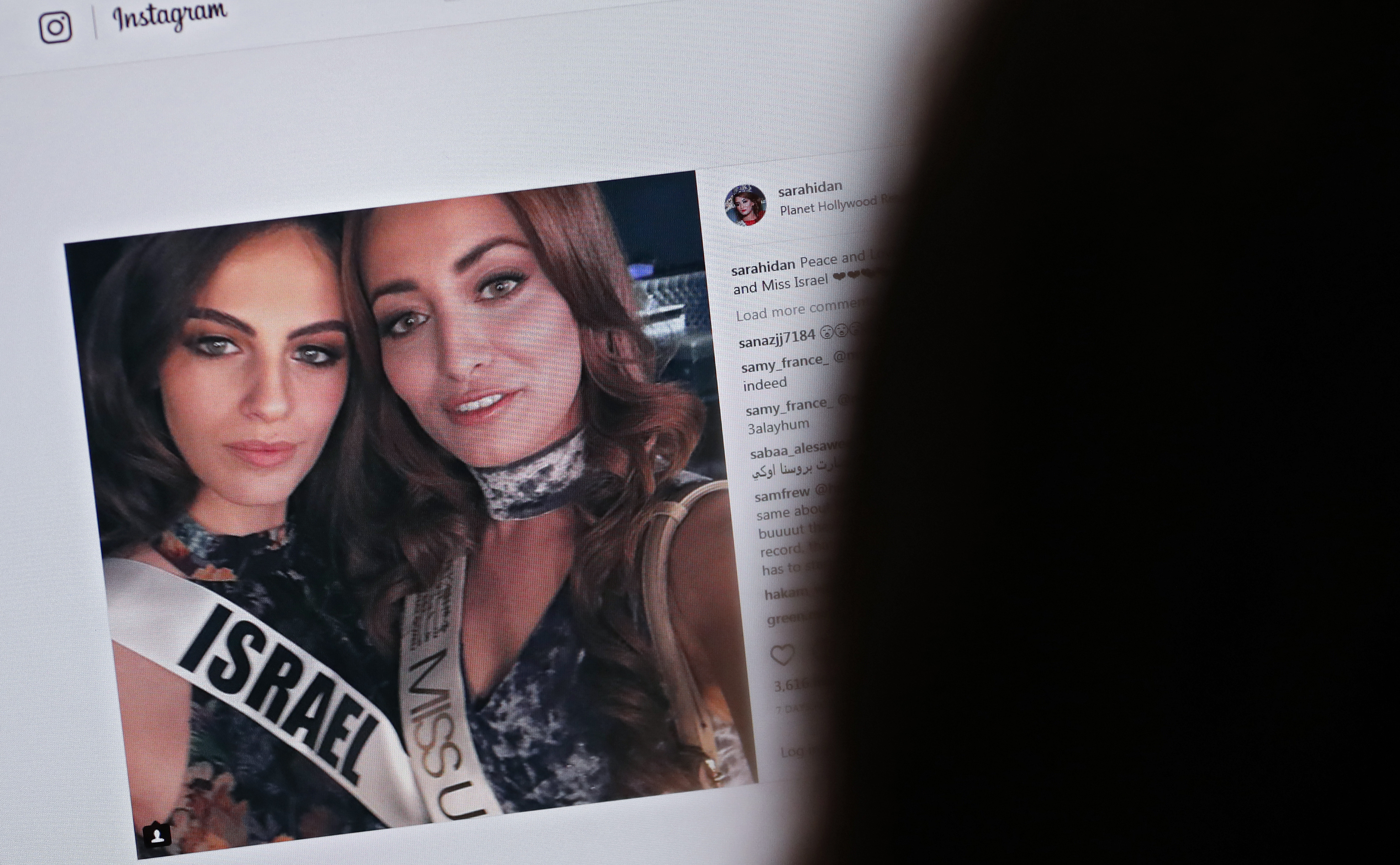 A picture taken on November 21, 2017 shows a picture posted by the Instagram profile of Sarah Idan on November 14, who holds the titles of "Miss Iraq USA 2016" and "Miss Iraq Universe 2017", as she is seen taking a "selfie" photograph with Adar Gandelsman, who holds the title of "Miss Universe Israel 2017", with a caption reading: "Peace and Love from Miss Iraq and Miss Israel #missuniverse". (THOMAS COEX&mdash;AFP/Getty Images)