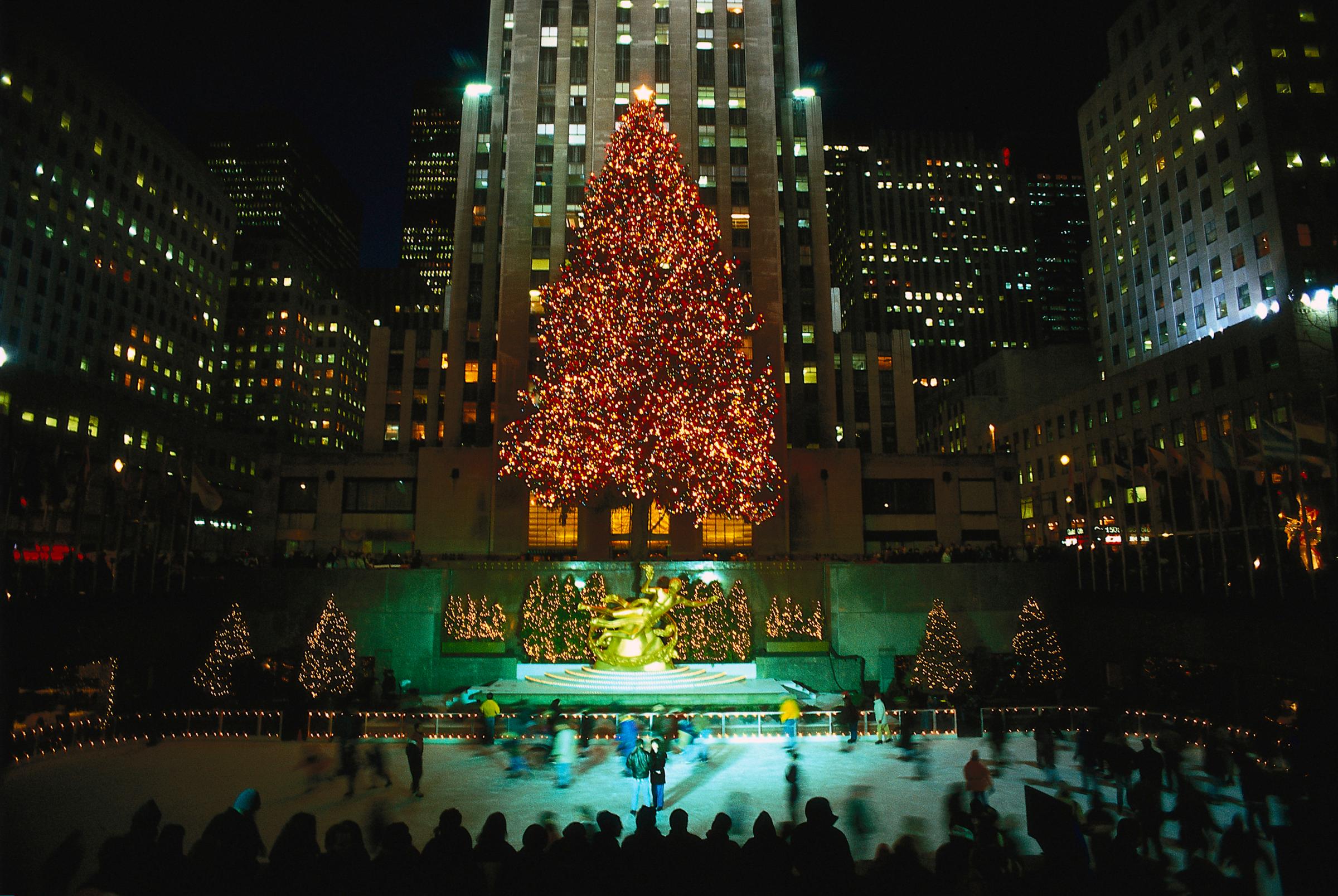 Illuminated christmas trees at the ice skating rink at the Rockefeller Center, Manhattan, New York City, USA, America