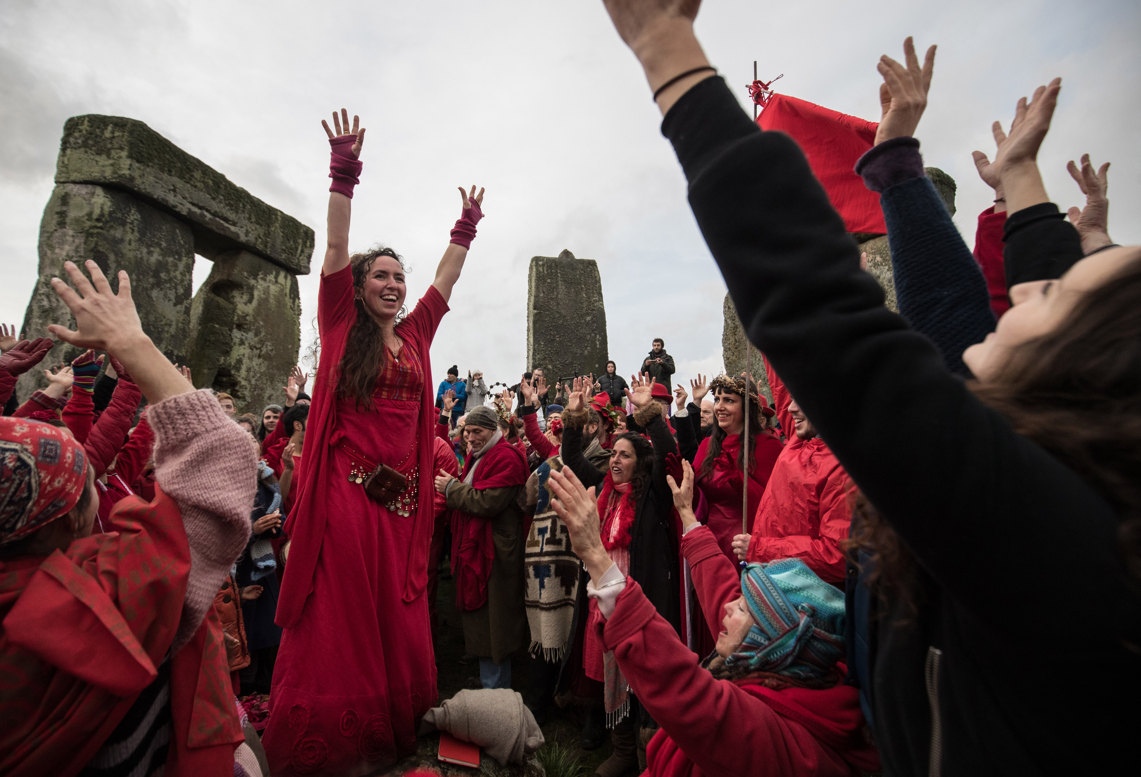 Members of the Shakti Sings choir sing as druids, pagans and revelers gather in the center of Stonehenge in Wiltshire, England to celebrate the 2016 winter solstice. (Matt Cardy—Getty Images)
