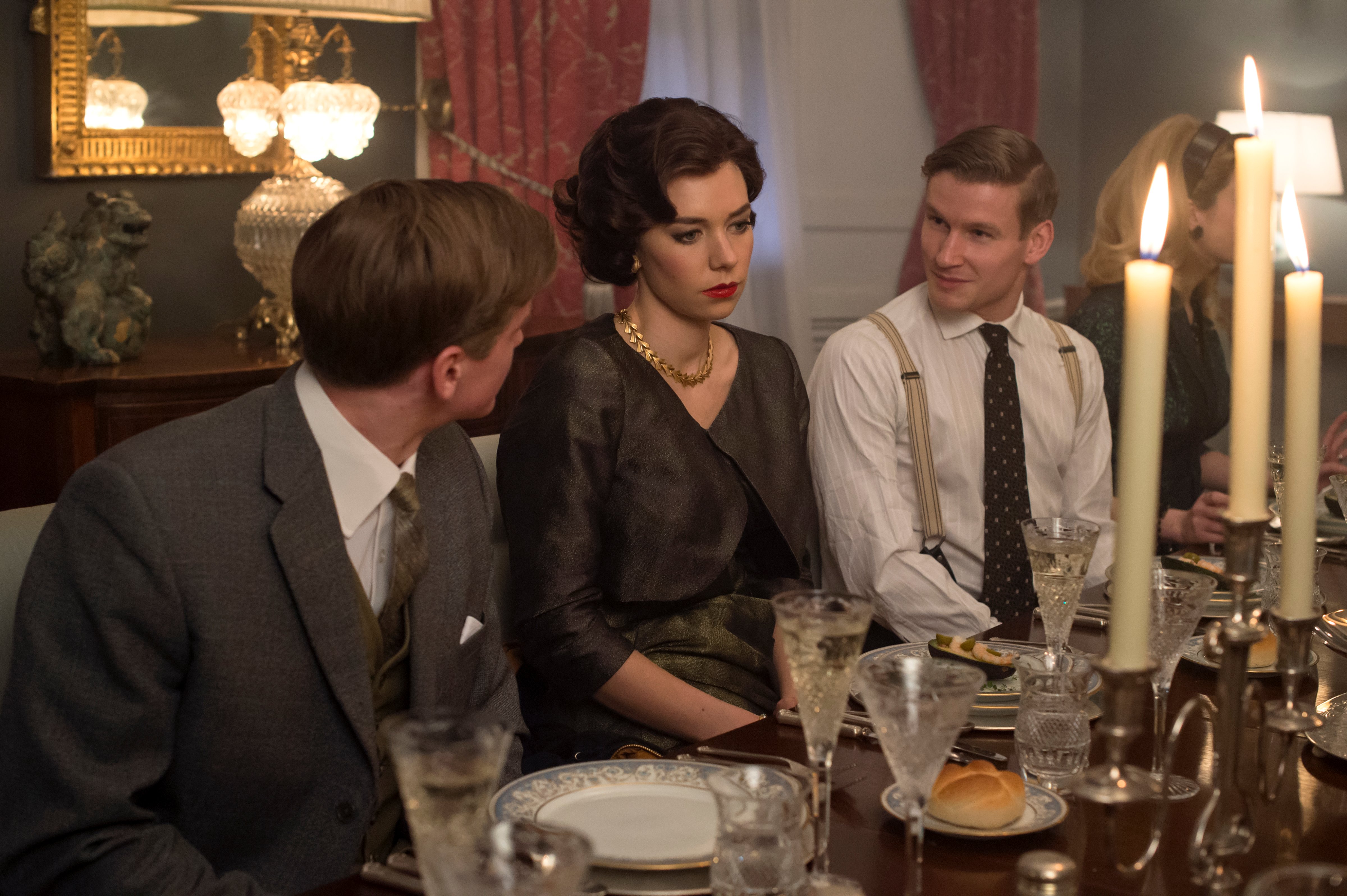 Princess Margaret and guests sit for supper at Elizabeth Cavendish's party in The Crown. (Alex Bailey / Netflix)