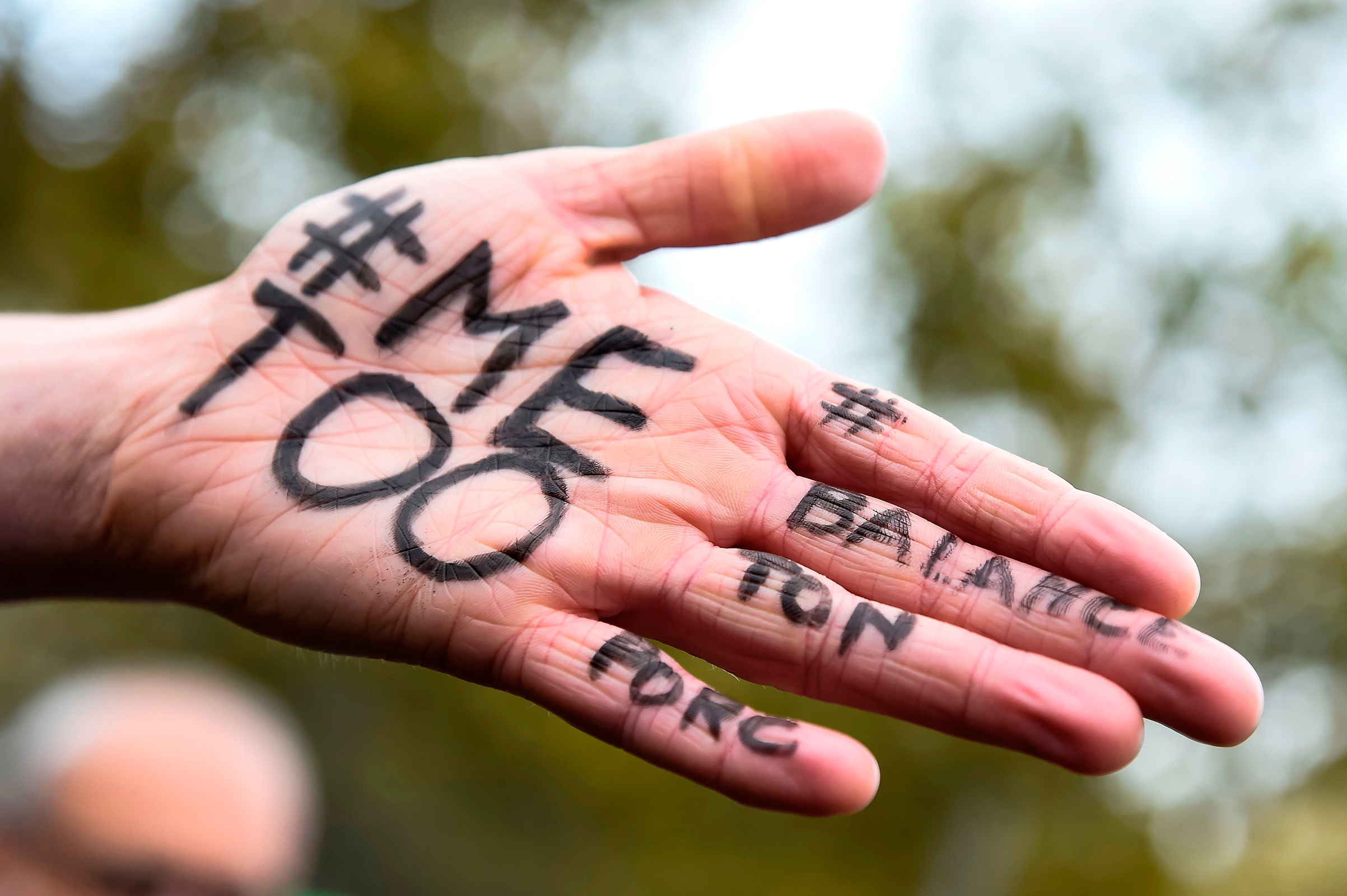 The messages "#Me too" and #Balancetonporc ("expose your pig") is written on the hand of a protester during a gathering against gender-based and sexual violence called by the Effronte-e-s Collective, on the Place de la Republique square in Paris on Oct. 29, 2017. (Bertrand Guay—AFP/Getty Images)