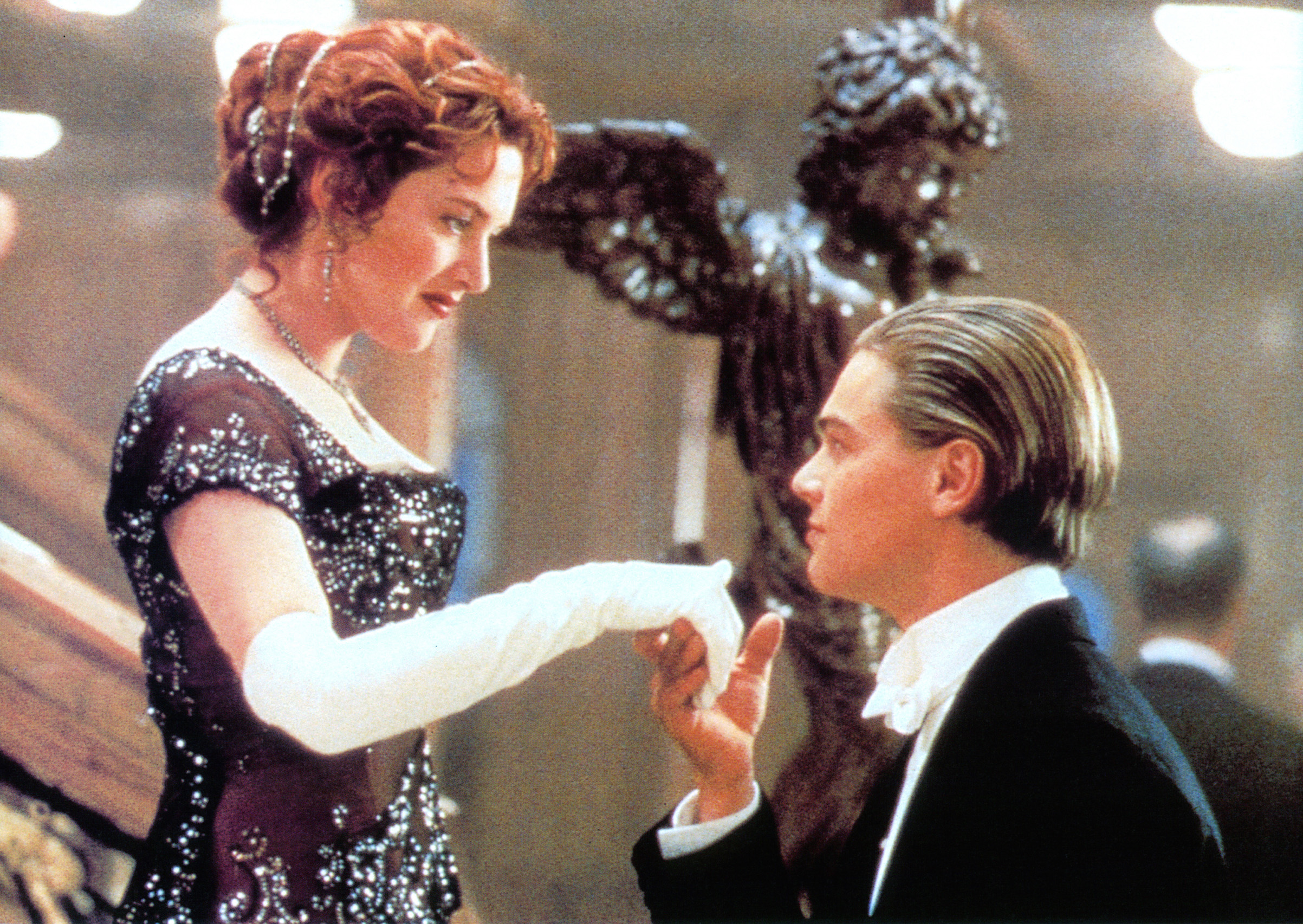 Kate Winslet offers her hand to Leonardo DiCaprio in a scene from the film <em>Titanic</em>, 1997. (20th Century-Fox/ Archive Photos—Getty Images)