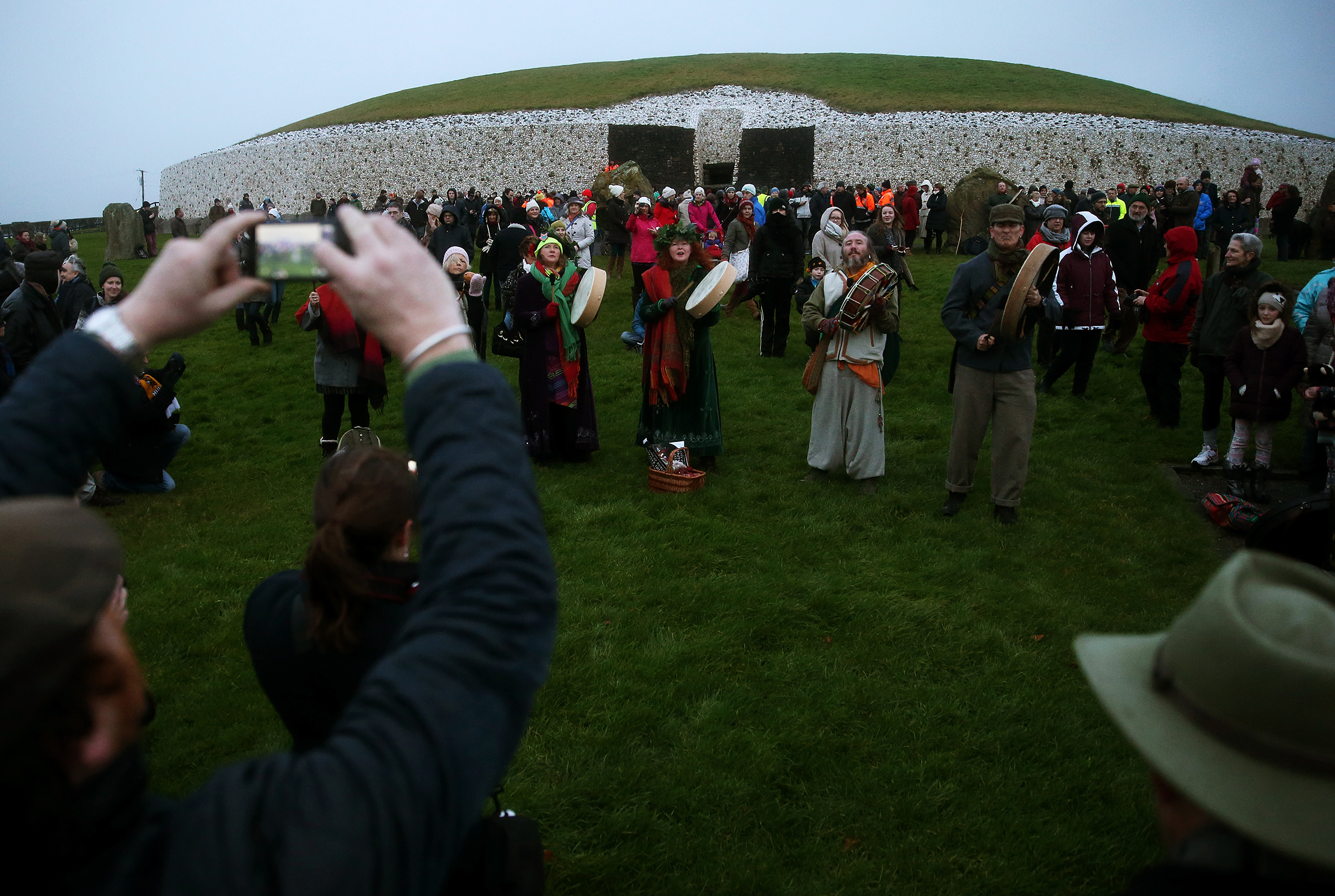 People gather for sunrise at Newgrange on the morning of the winter solstice on Dec. 21, 2014. (Brian Lawless—PA Wire/AP)
