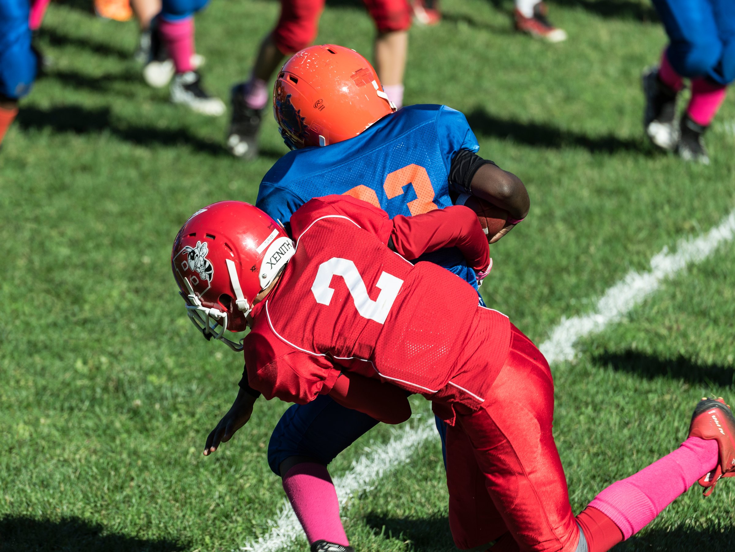 Making a tackle during a Pop Warner football game