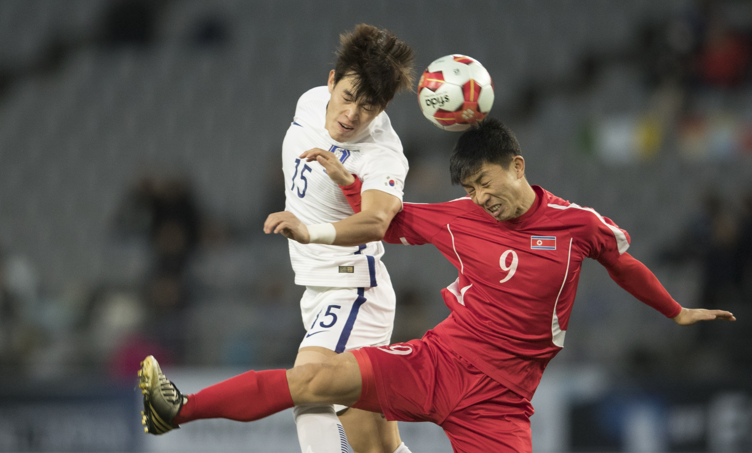 Pak Song Chol (#9) of North Korea and Lee changmin (#15) of South Korea in action during the EAFF E-1 Men's Football Championship at the Ajinomoto Stadium on December 12, 2017 in Chofu, Tokyo, Japan. (XIN LI—Getty Images)