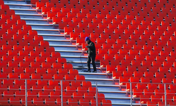 This picture taken on December 12, 2017 shows a South Korean worker setting up a cable at the Olympic Stadium, the venue of the opening and closing ceremony for the PyeongChang 2018 Winter Olympic Games, in Pyeongchang.