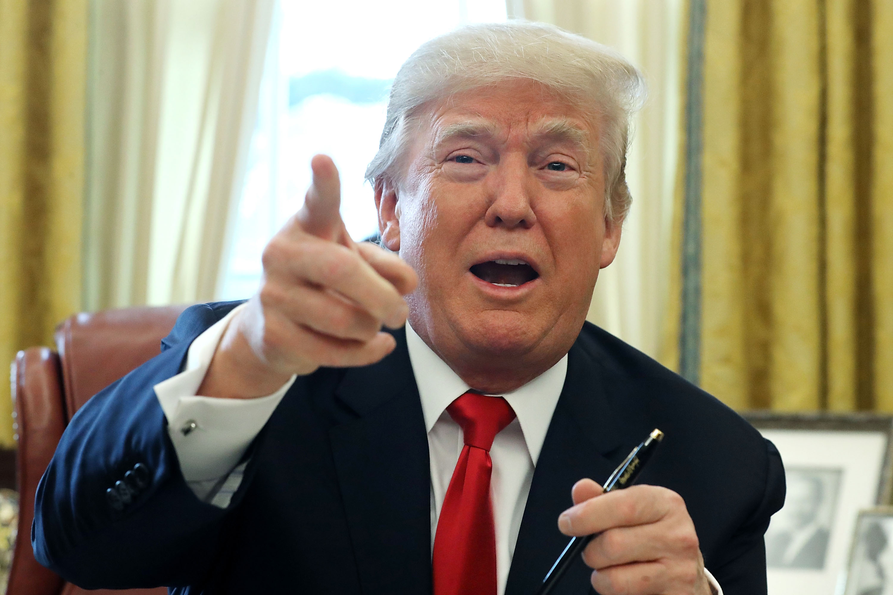 U.S. President Donald Trump talks with journalists after signing tax reform legislation into law in the Oval Office Dec. 22, 2017 in Washington, DC. (Chip Somodevilla—Getty Images)