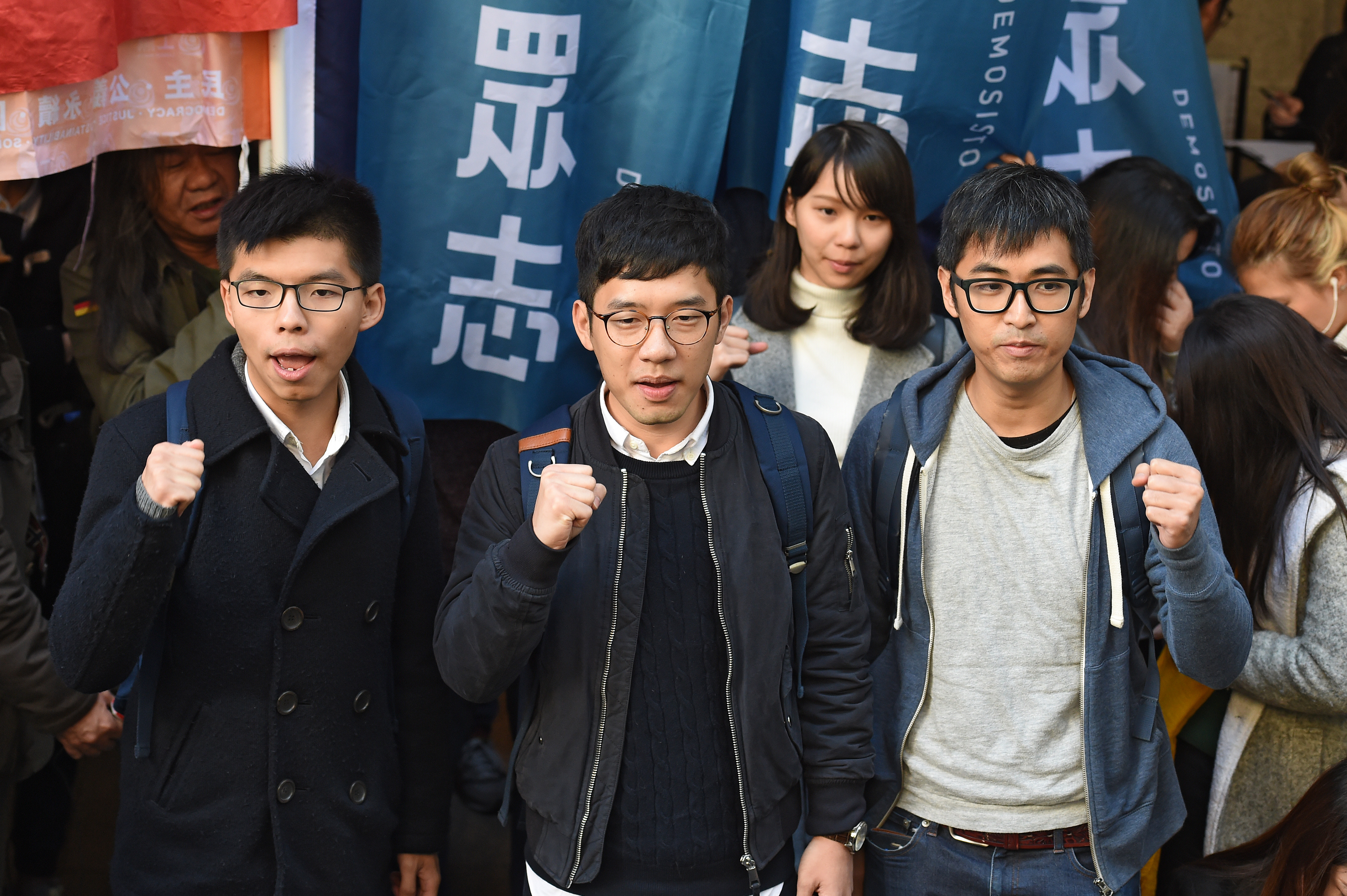 Hong Kong democracy activists Joshua Wong, Nathan Law and Alex Chow outside Hong Kong's Court of Final Appeal before a hearing on Jan. 16, 2018. (Anthony Wallace—AFP/Getty Images)