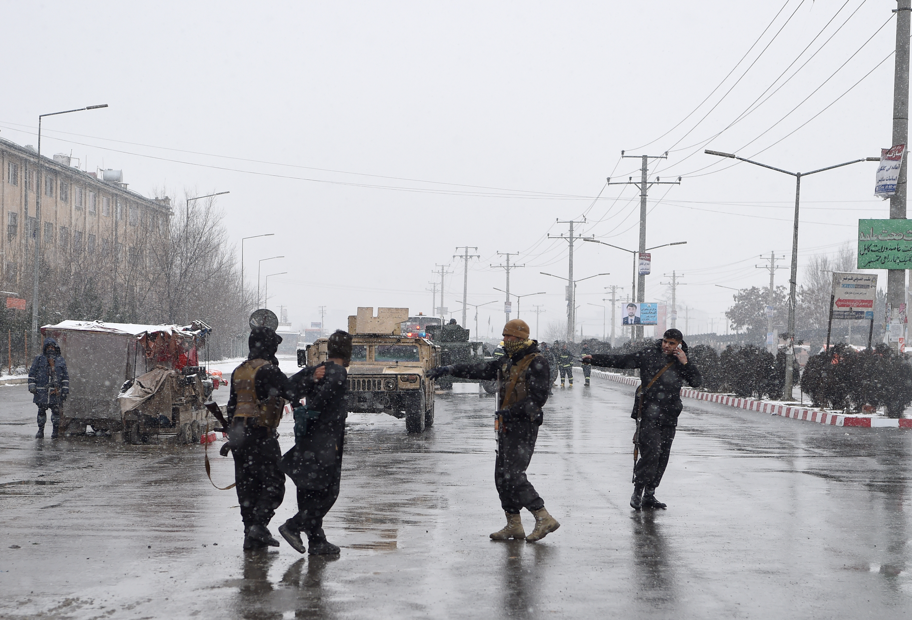 Afghan security personnel detain a suspect as they guard the site of an attack near the Marshal Fahim Military Academy base in Kabul on January 29, 2018. (Wakil Kohsar—AFP/Getty Images)