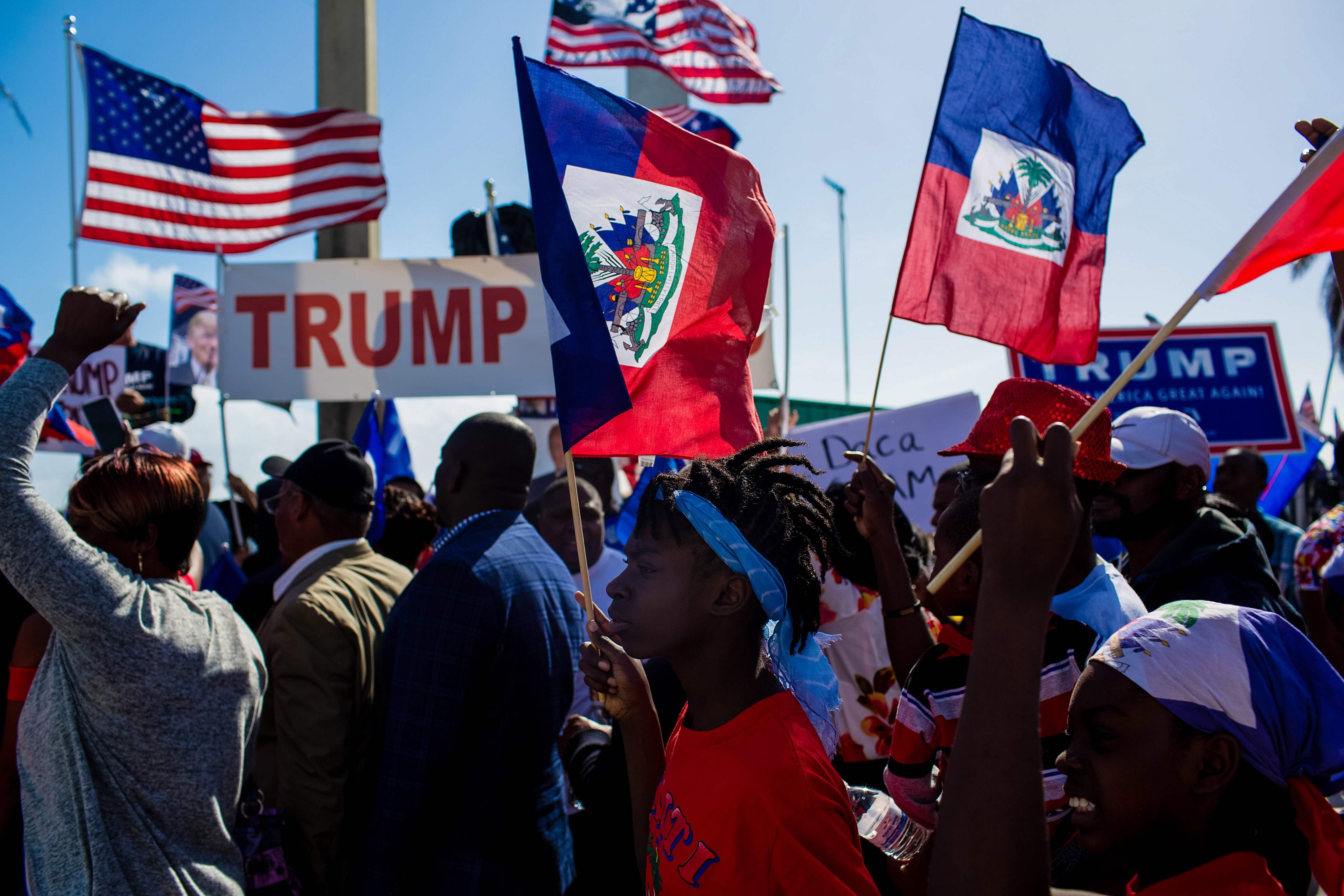 Demonstrators hold Haitian and American flags during a protest against U.S. President Donald Trump. (Bloomberg&mdash;Bloomberg via Getty Images)