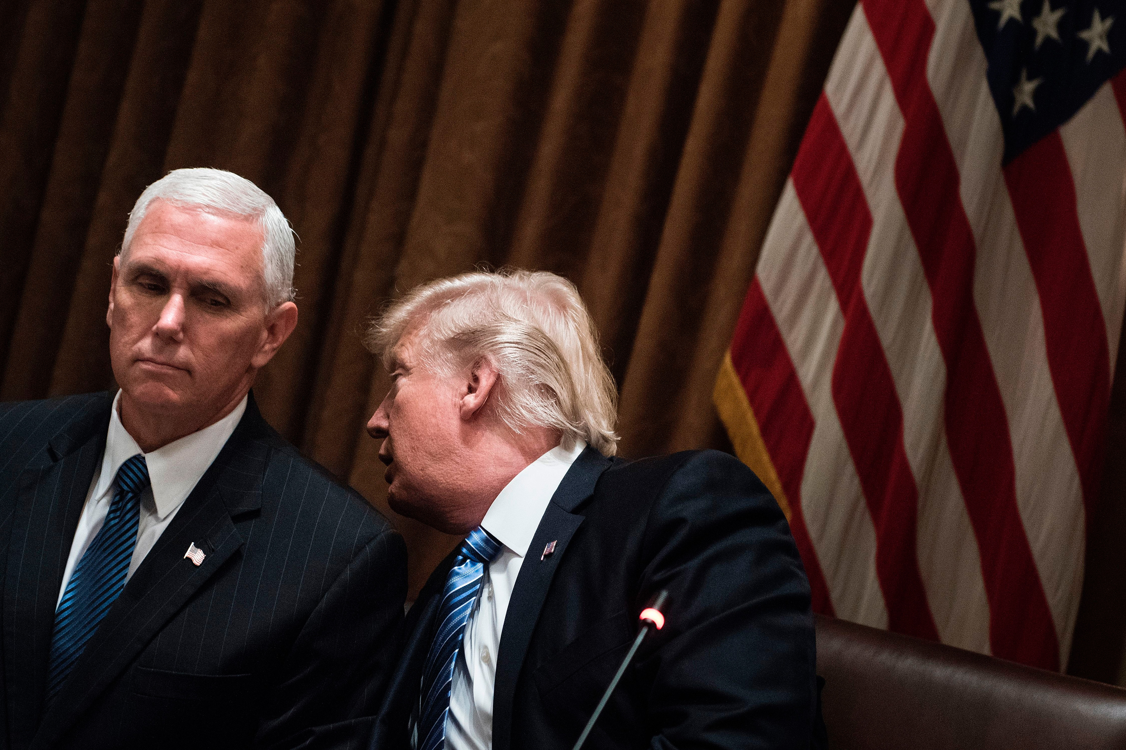 US President Donald Trump whispers to US Vice President Mike Pence before a meeting with South Korea's President Moon Jae-in in the Cabinet Room of the White House June 30, 2017 in Washington, DC. (Brendan Smialowski—AFP/Getty Images)