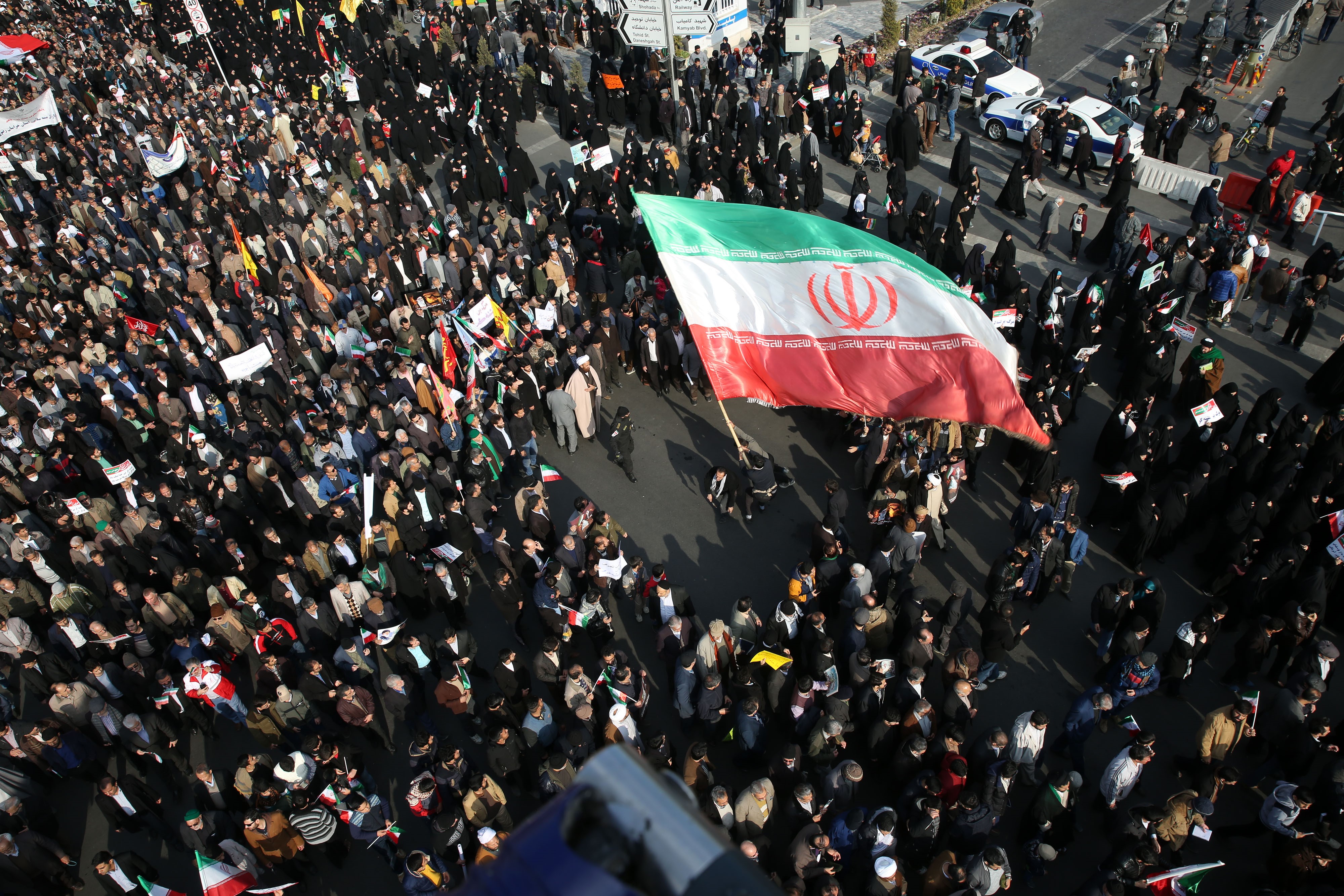 Thousands of Iranians hold banners and posters as they take part in a pro-government rally in Mashhad, Iran on January 4, 2018. (Nima Najafzadeh—Anadolu Agency/Getty Images)