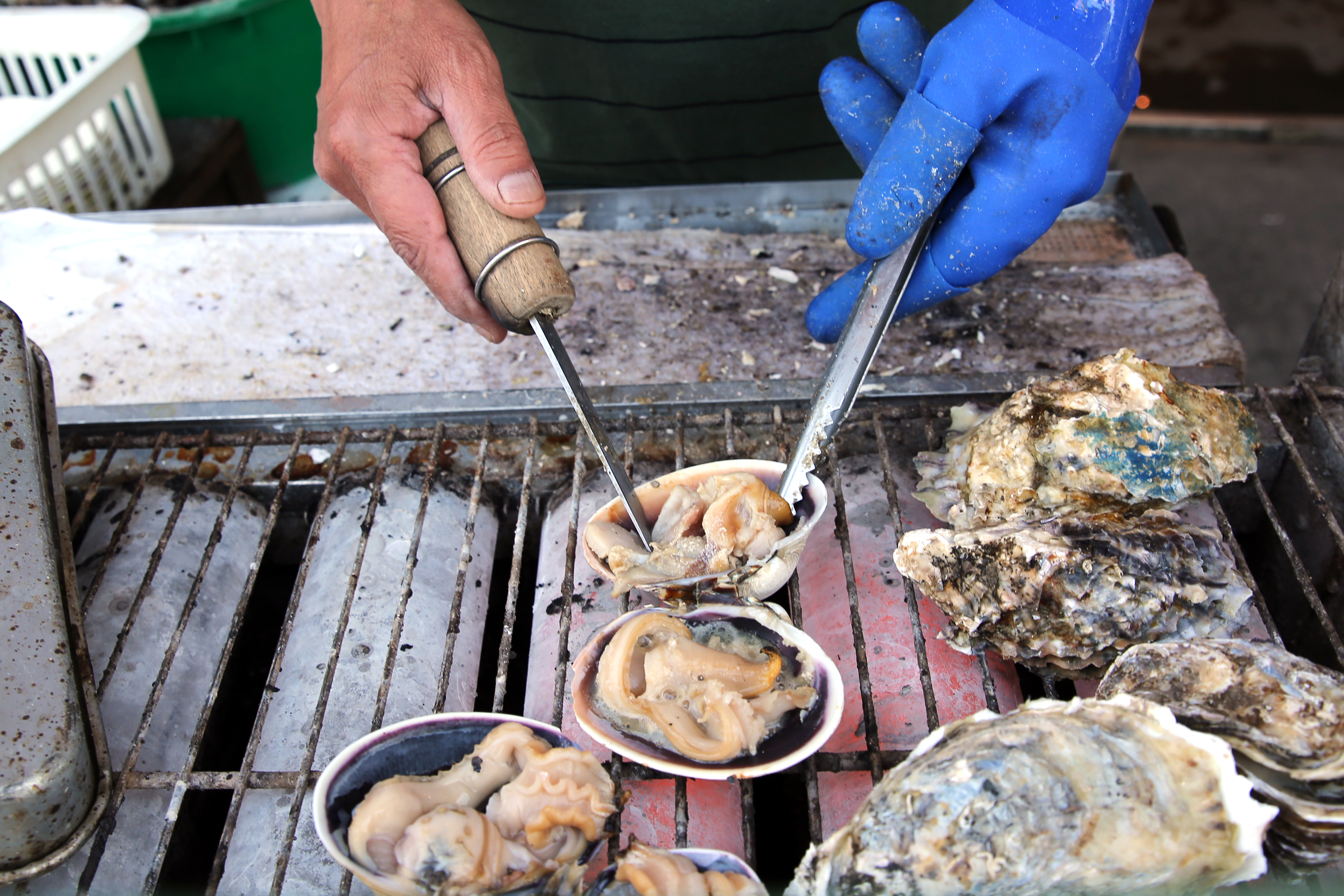ISE, JAPAN - MAY 05: An employee prepares clams for barbecue on a road side stall at Okage Yokocho, a traditional shopping street on May 5, 2016 in Ise, Japan. Ise-Shima prepares for the G7 summit which is to be held on May 26 and 27, 2016. (Photo by Buddhika Weerasinghe/Getty Images) (Buddhika Weerasinghe—Getty Images)