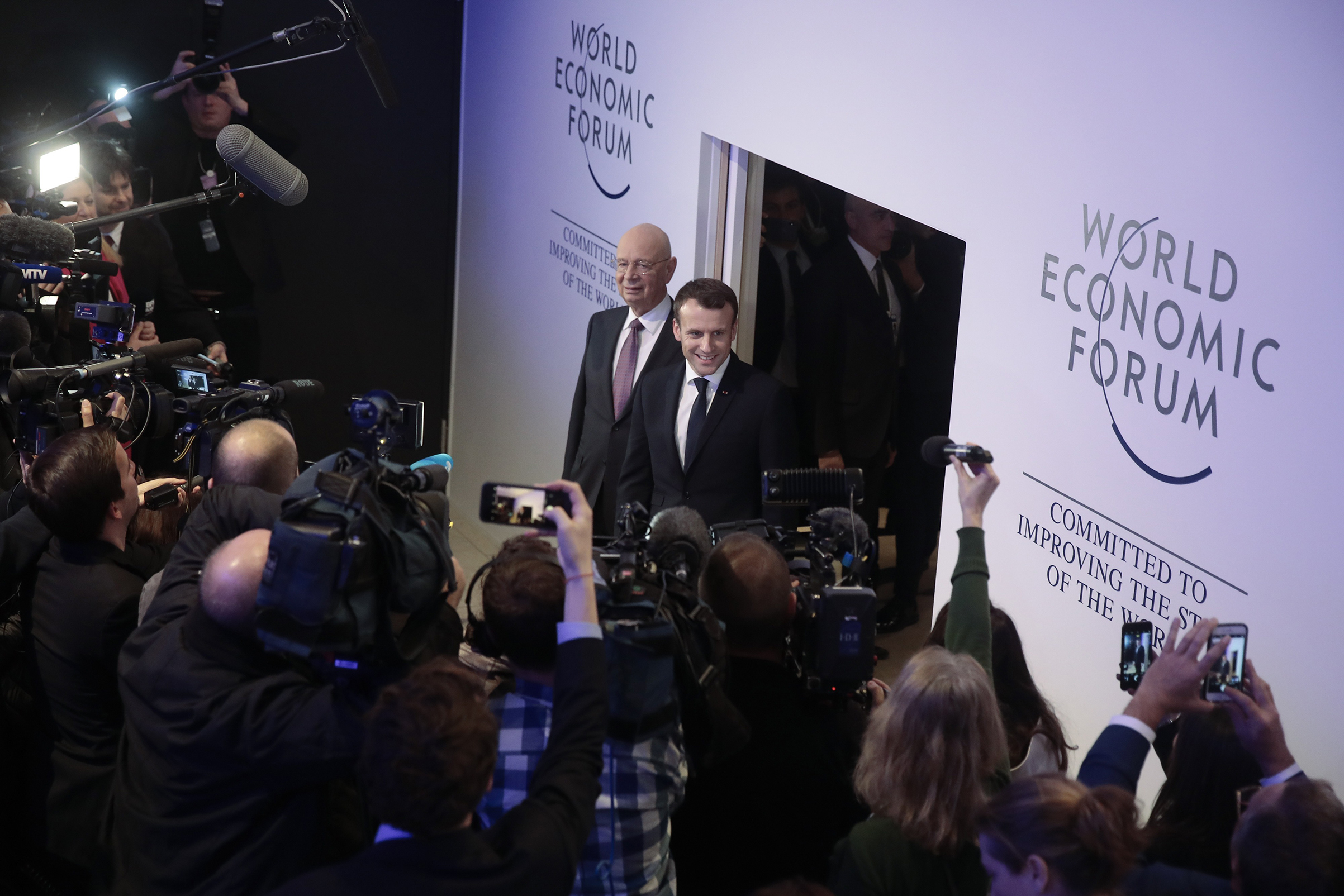 Klaus Schwab, left, executive chairman of the World Economic Forum, and French President Emmanuel Macron in Davos on Jan. 24 (Jason Alden—Bloomberg/Getty Images)