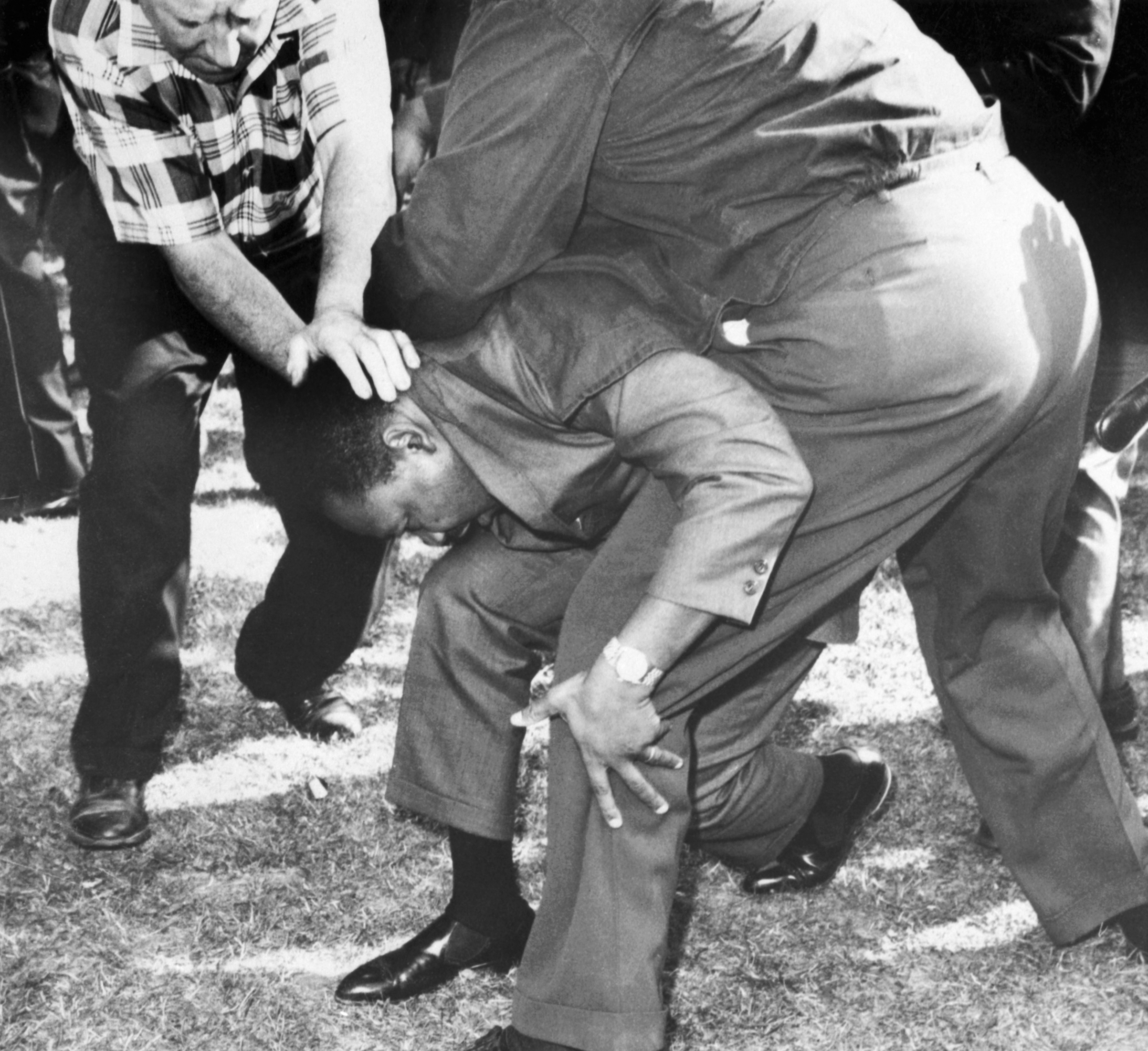 Struck on the head by a rock thrown by a group of hecklers, Dr. Martin Luther King falls to one knee. Dr. King regained his feet and led a group of marchers demonstrating alleged housing discrimination through an all-white district in Chicago, Aug. 5, 1966. (Bettmann / Getty Images)