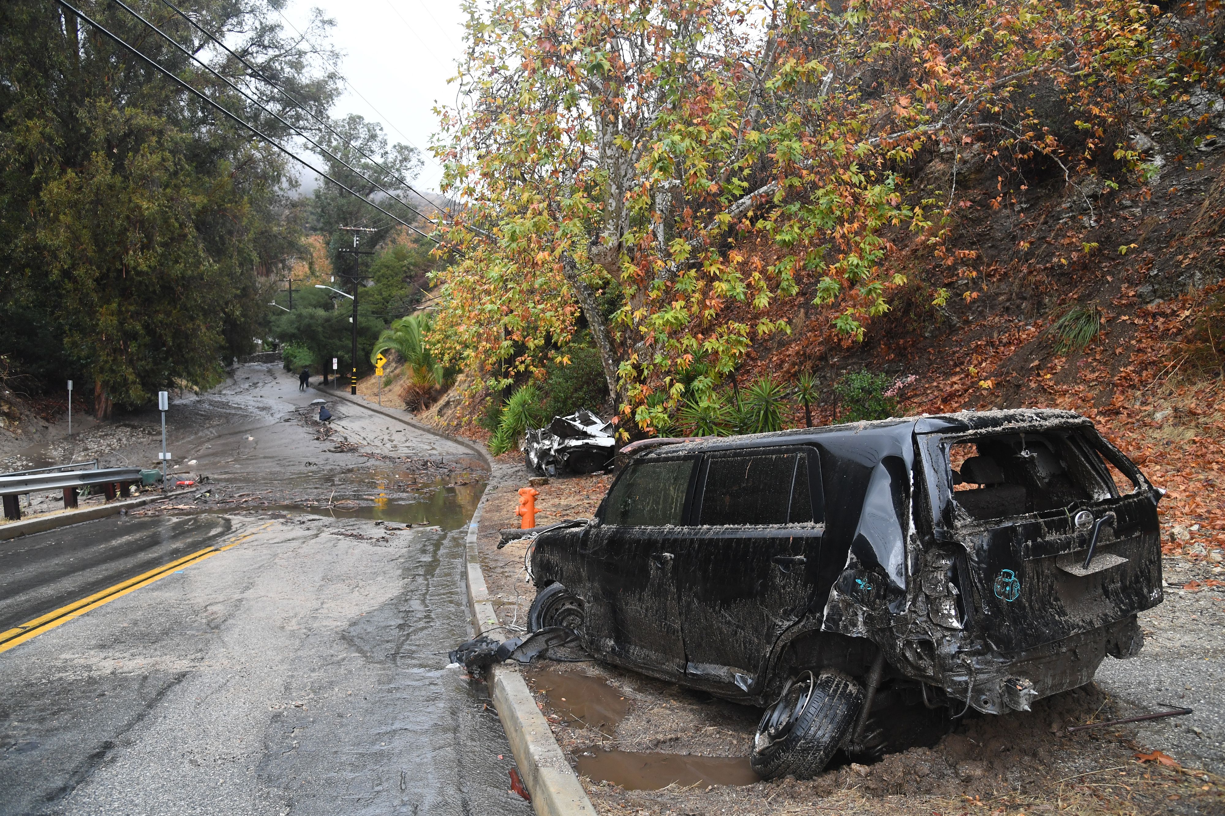Two cars washed downhill in a rain-driven mudslide are seen in a neighborhood under mandatory evacuation in Burbank, California, January 9, 2018. Mudslides unleashed by a ferocious storm demolished homes in southern California, authorities said Tuesday. (ROBYN BECK—AFP/Getty Images)
