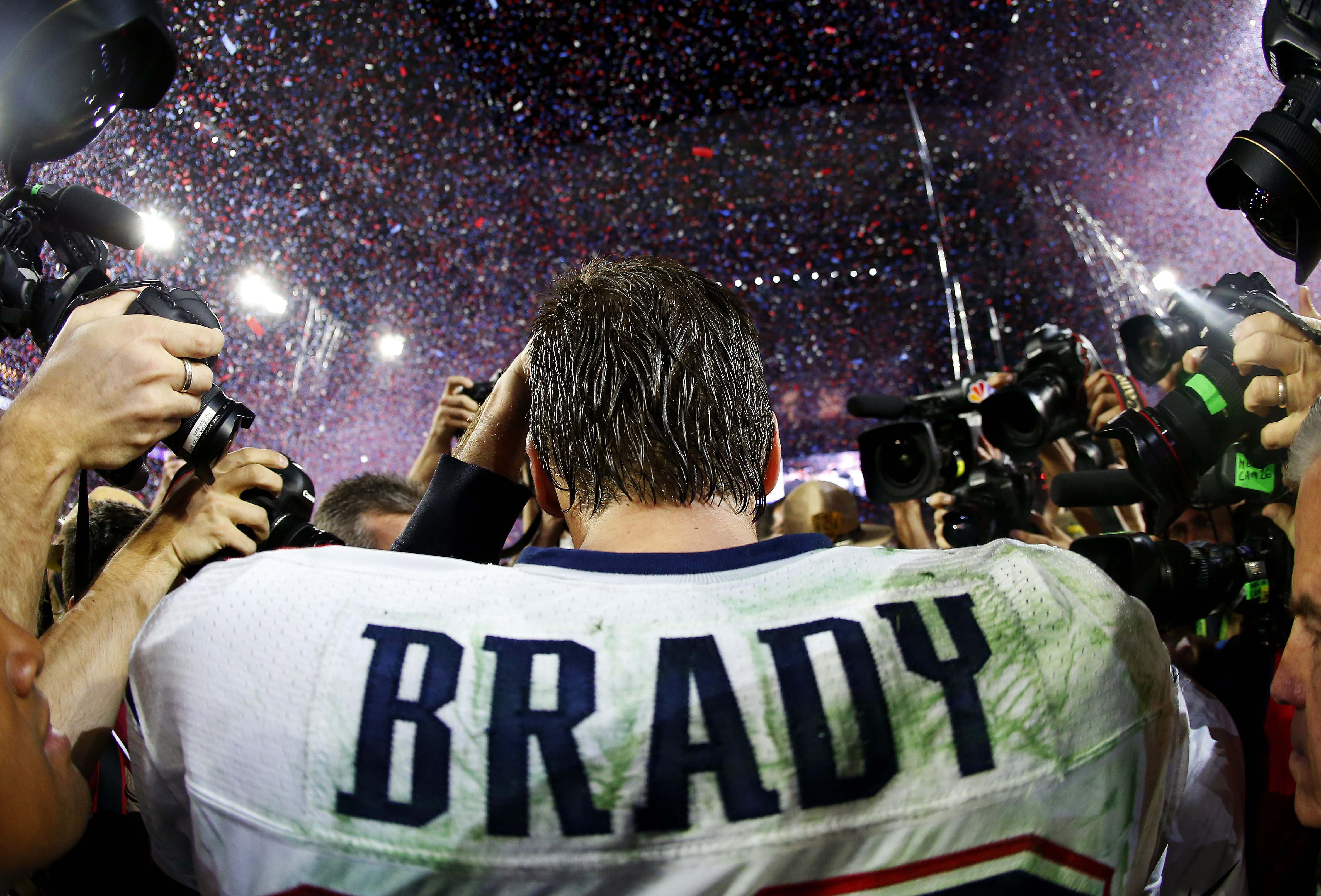 Tom Brady #12 of the New England Patriots is surrounded by the media after defeating the Seattle Seahawks 28-24 during Super Bowl XLIX at University of Phoenix Stadium on February 1, 2015 in Glendale, Arizona. (Tom Pennington—Getty Images)