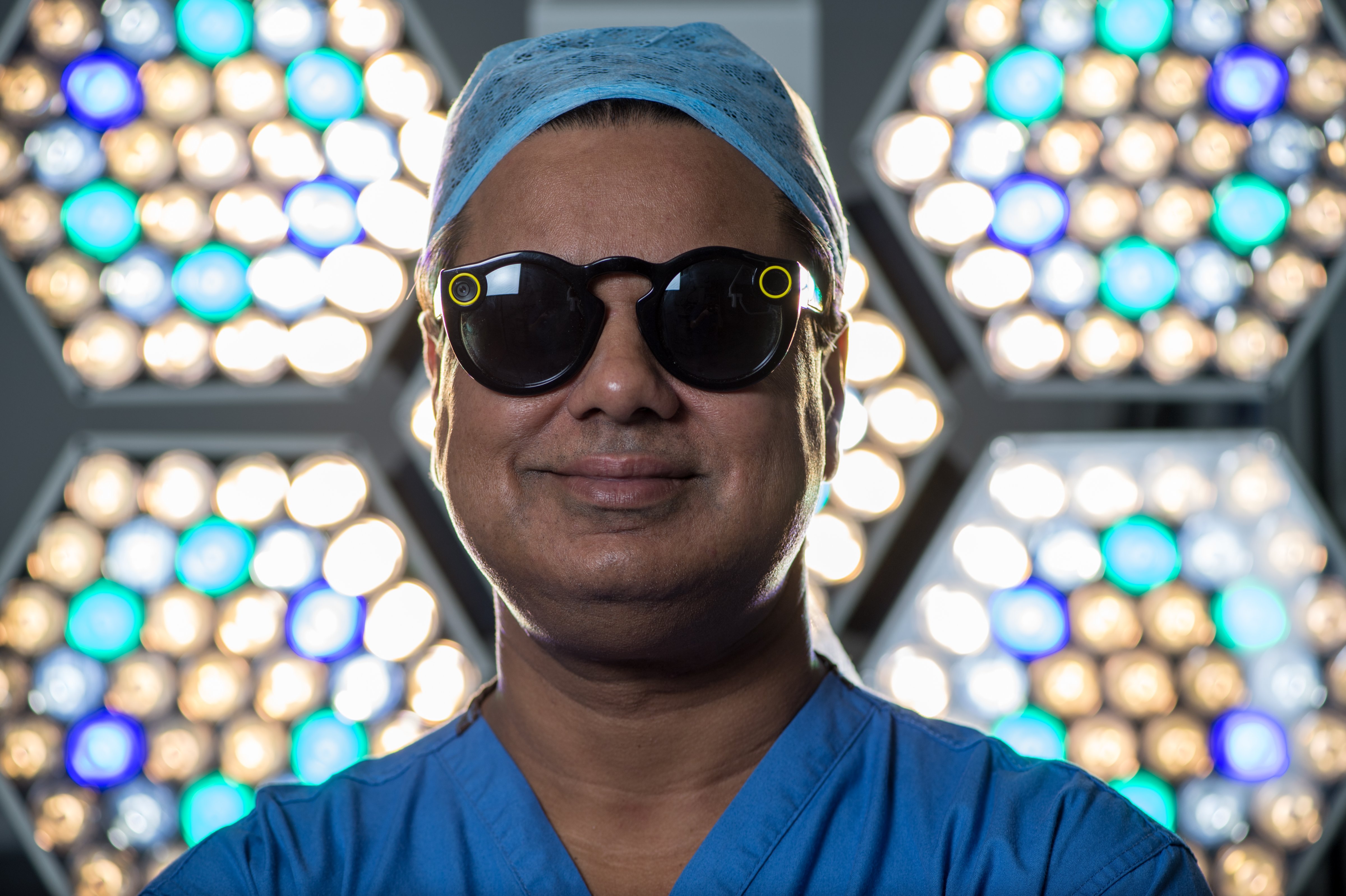 Surgeon Shafi Ahmed poses for a photograph wearing a pair of Snap Inc. Spectacles inside his operating theater at the Royal London Hospital, part of the Barts Health NHS Trust, in London, U.K., on Thursday, Jan. 11, 2018. (Chris J. Ratcliffe&mdash;Bloomberg/Getty Images)
