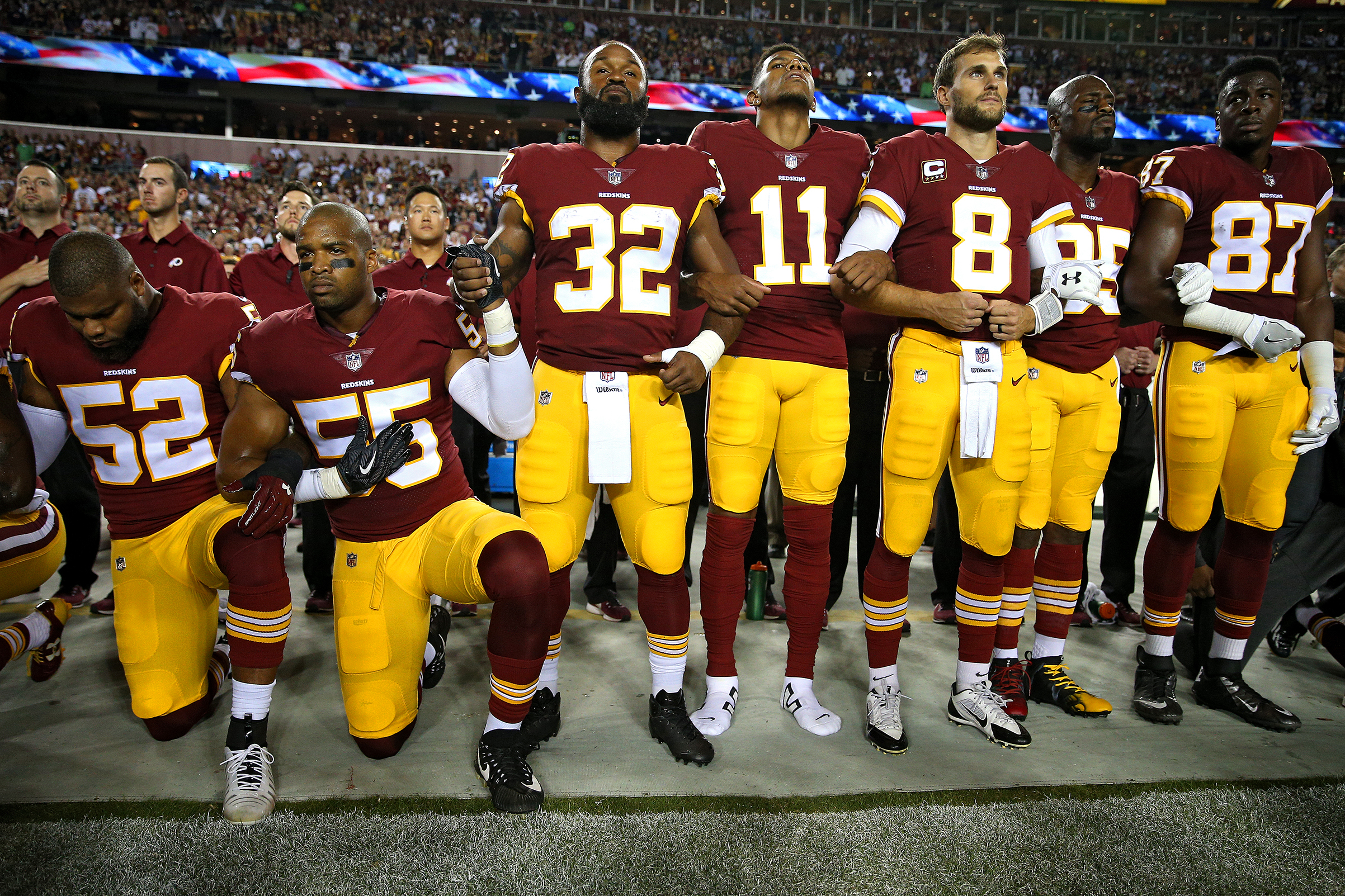 Washington Redskins players during the the national anthem before the game against the Oakland Raiders at FedExField on Sept. 24, 2017. (Patrick Smith—Getty Images)