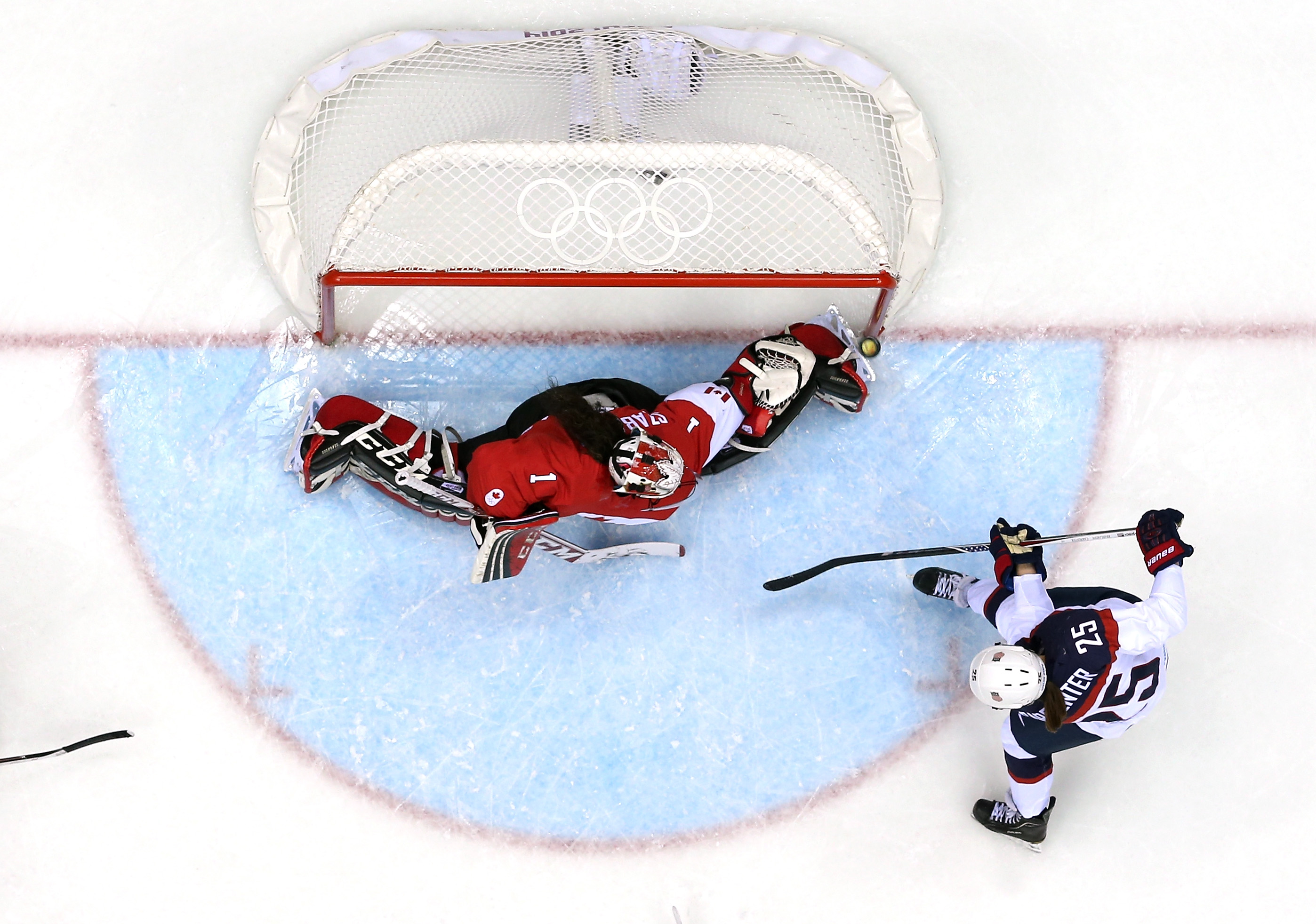 Alex Carpenter #25 of United States shoots and scores against Shannon Szabados #1 of Canada in the third period during the Ice Hockey Women's Gold Medal Game on day 13 of the Sochi 2014 Winter Olympics at Bolshoy Ice Dome on February 20, 2014 in Sochi, Russia. (Martin Rose—Getty Images)