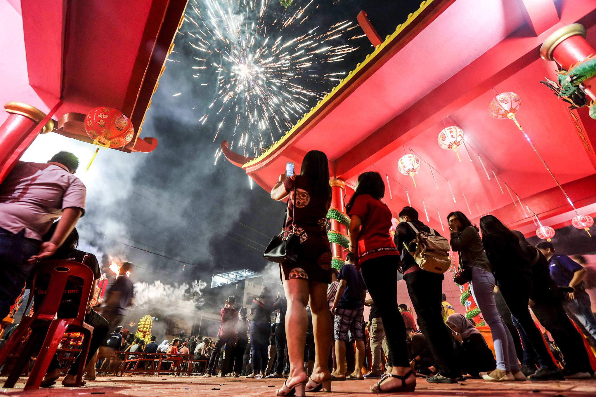 Fireworks light up the sky during the Chinese New Year Eve celebrations at the Pak Pie Hut Cou temple in Medan, North Sumatra, Indonesia, Feb. 16, 2018.