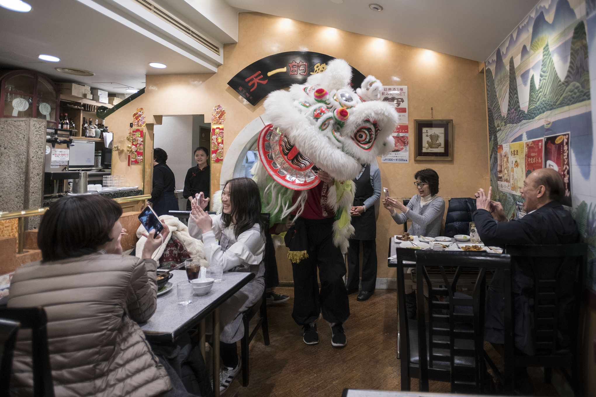 A lion dance is performed inside a restaurant as part of Chinese New Year celebrations in Chinatown, Yokohama, near Tokyo, Feb. 16, 2018.
