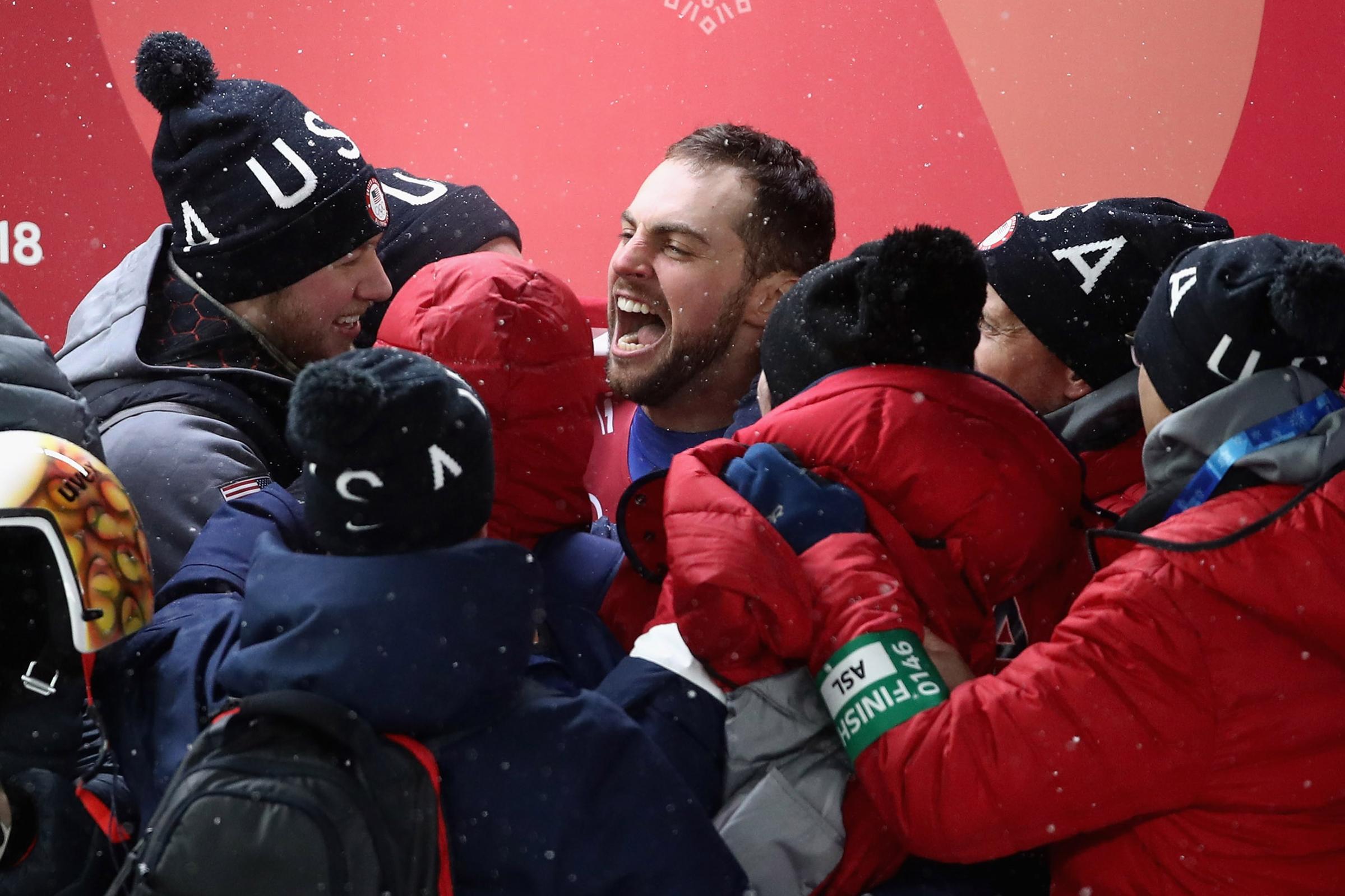 Chris Mazdzer of the United States celebrates after he won silver in the Luge Men's Singles on Feb. 11, 2018.