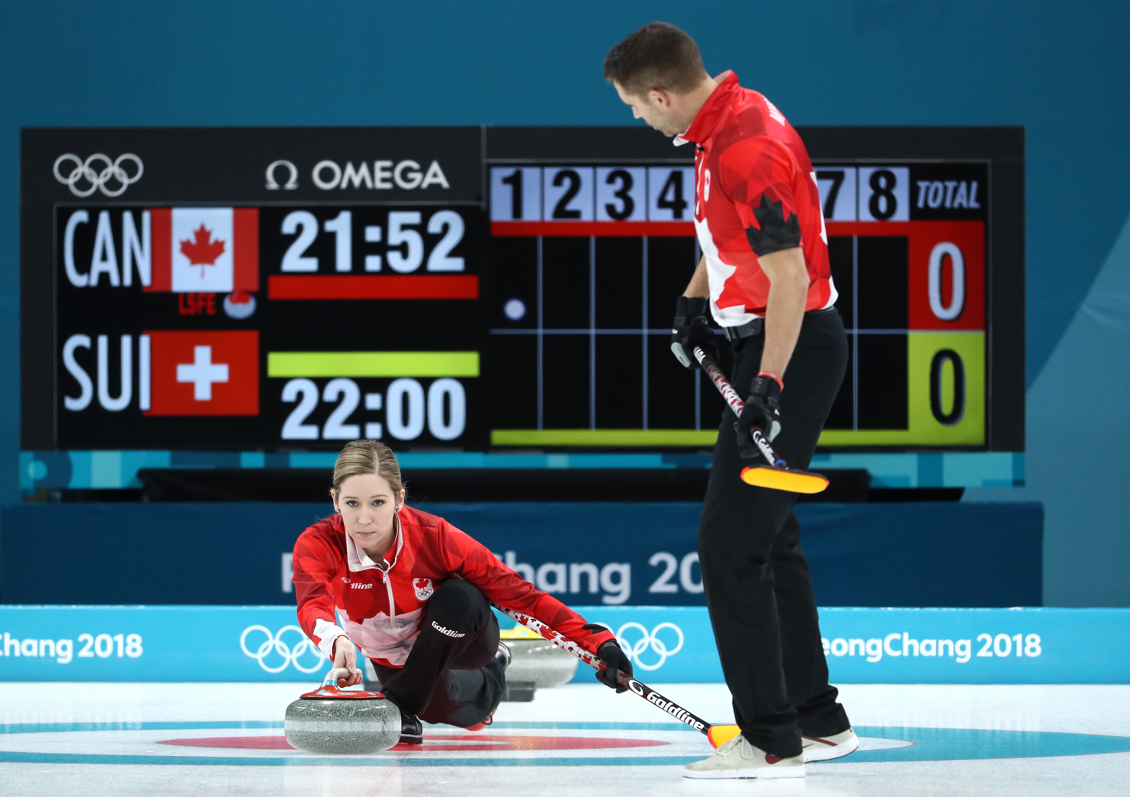 Kaitlyn Lawes and John Morris of Canada deliver a stone against Switzerland during the Curling Mixed Doubles Gold Medal Game in PyeongChang on Feb. 13, 2018. Jamie Squire—Getty Images (Jamie Squire—Getty Images)