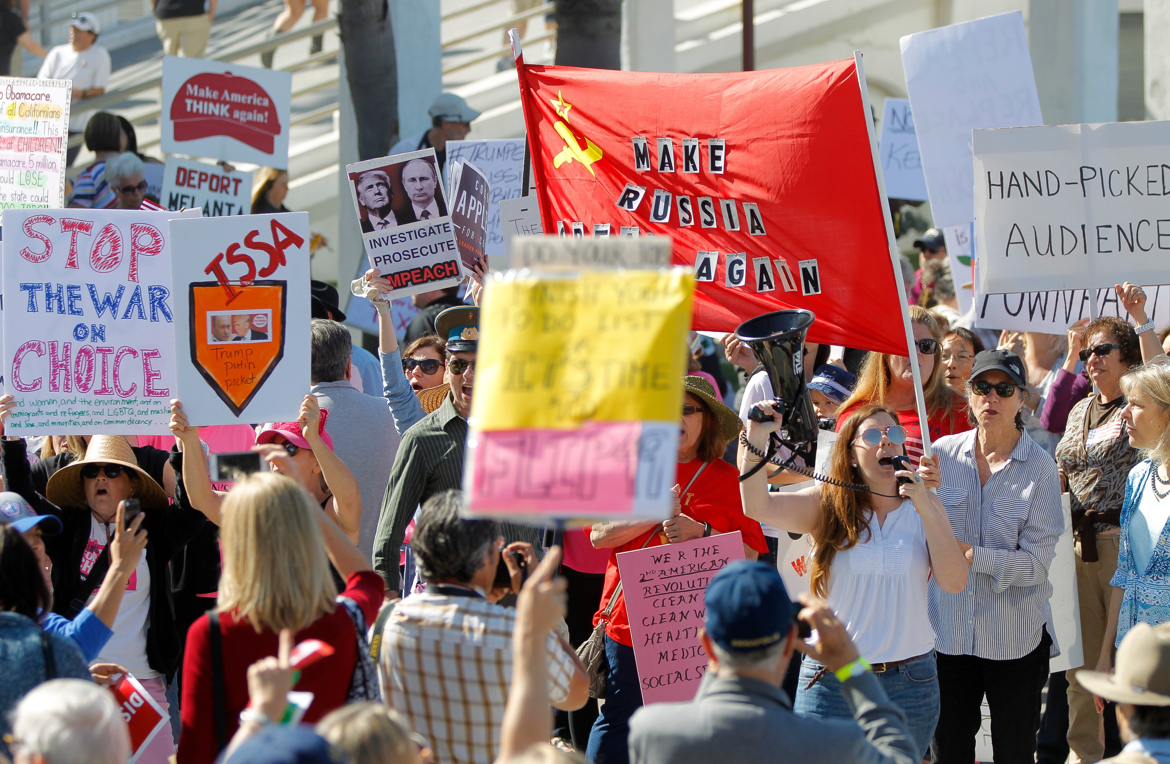 People protest outside of the Junior Seau Beach Community Center as U.S. Rep. Darrell Issa holds a town hall meeting inside on Saturday, March 11, 2017 in Oceanside, Calif.   Issa held the meetings to discuss health care reform with constituents from his district, which straddles Orange County and San Diego County. (Hayne Palmour IV—AP)
