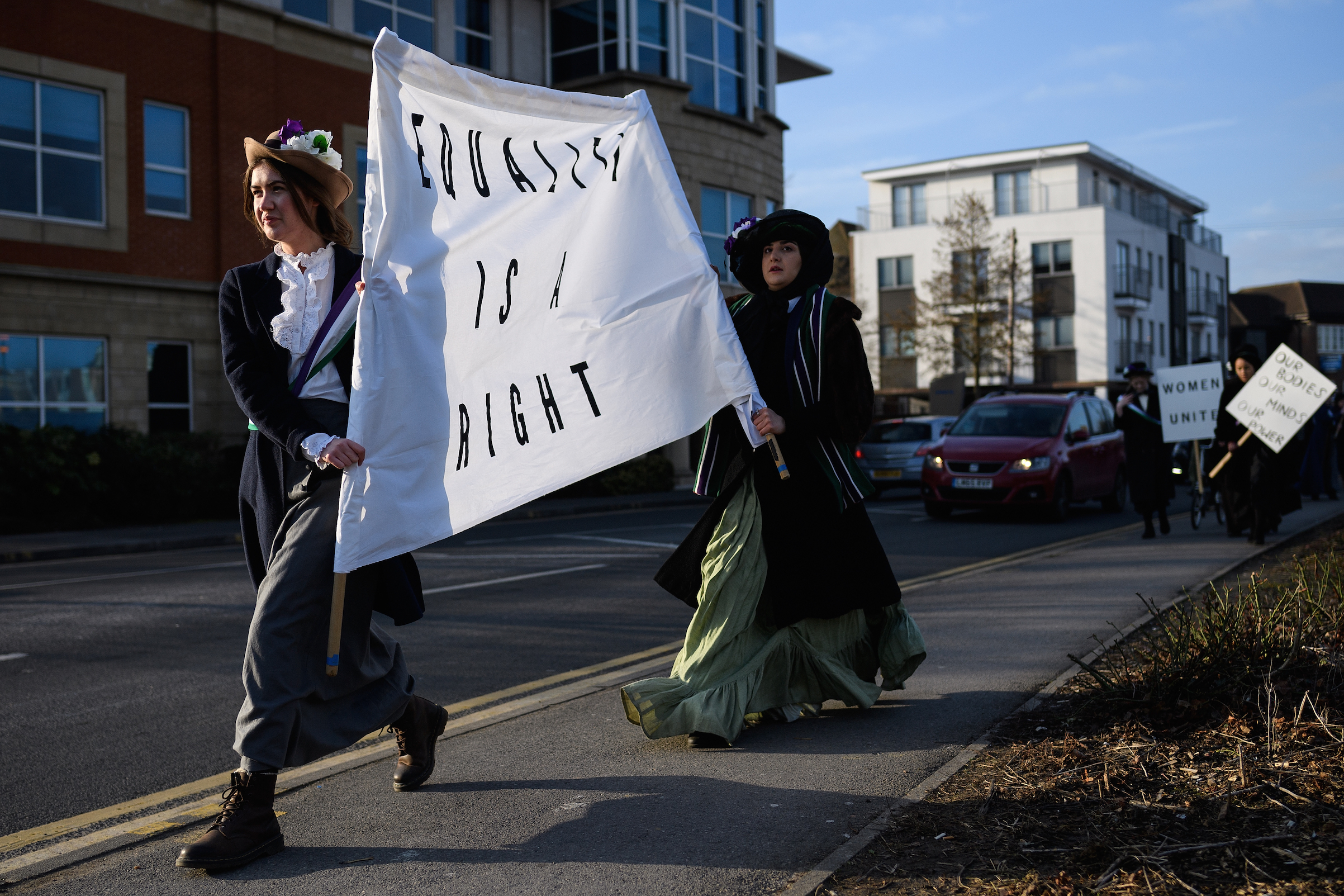 Students recreate a suffragette protest march through the town center at Royal Holloway, University of London on Feb. 6, 2018 in Egham, England. (Leon Neal—Getty Images)