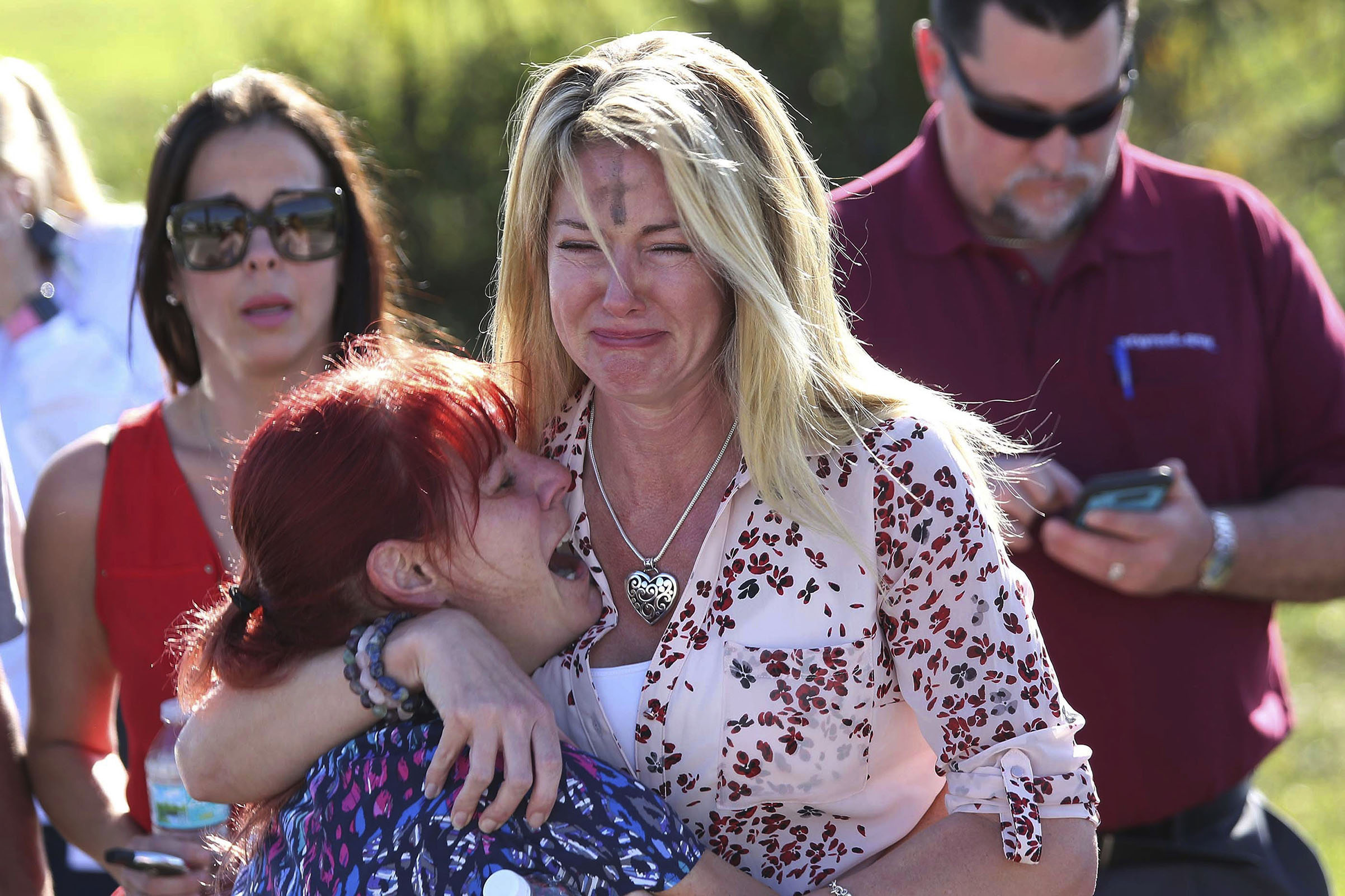 Parents wait for news after a reports of a shooting at Marjory Stoneman Douglas High School in Parkland, Fla., on Feb. 14, 2018. (Joel Auerbach—AP)