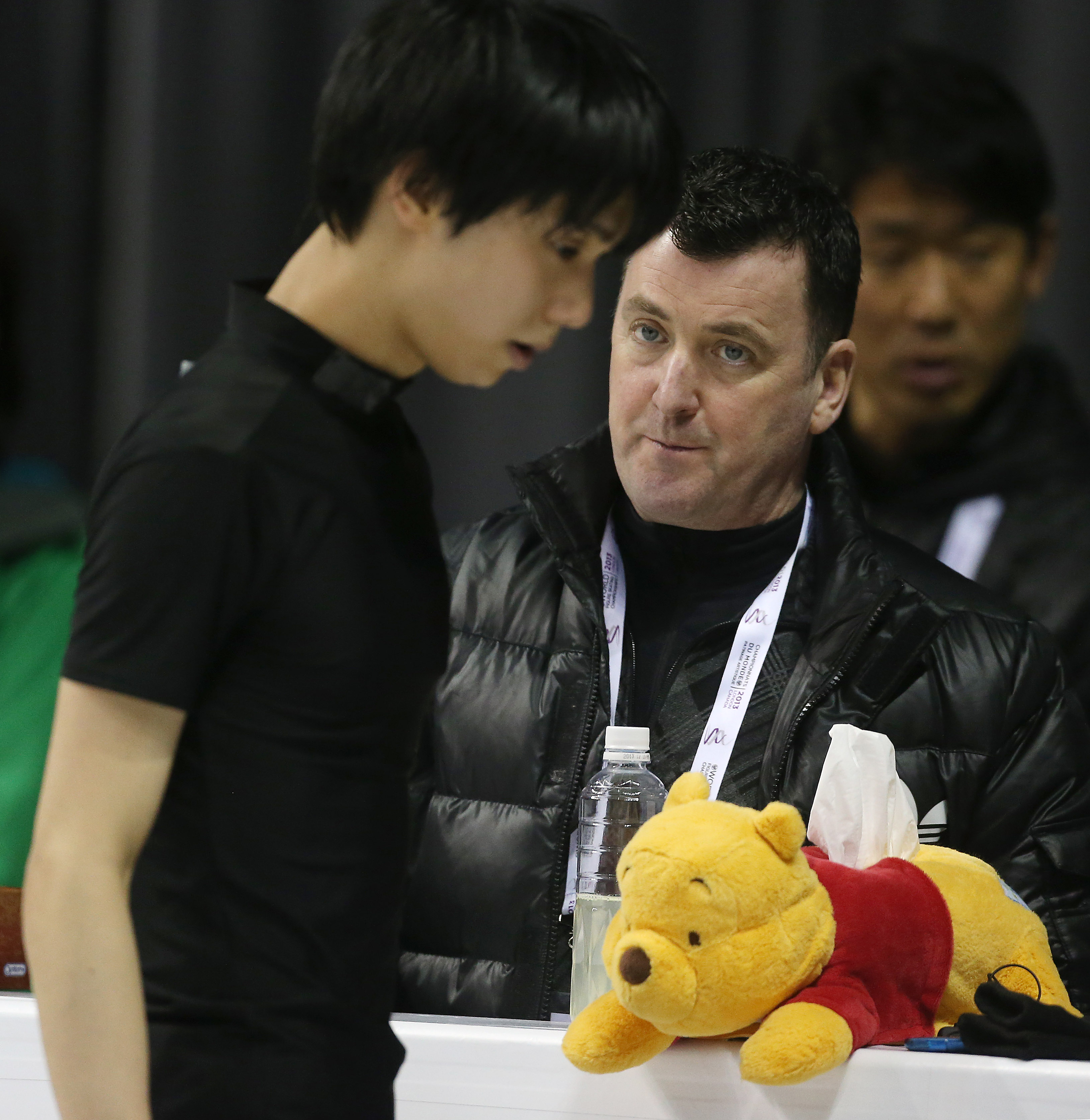 Brian Orser and Winnie the Pooh look on as their skater, Japan's Yuzuru Hanyu practices in preparation for the ISU World Figure Skating Championships at Budweiser Gardens. (Steve Russell&mdash;Toronto Star via Getty Images)