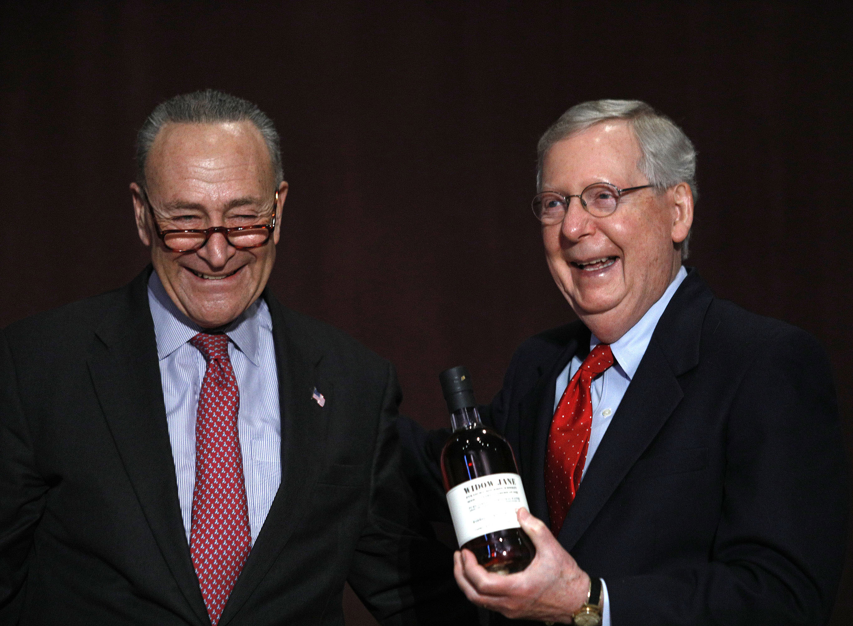 U.S. Senate Democratic Leader Chuck Schumer  (left) (D-NY), presents U.S. Senate Majority Leader Mitch McConnell (right) (R-KY) with a bottle of bourbon at the University of Louisville's McConnell Center where Schumer was scheduled to speak February 12, 2018 in Louisville, Kentucky. (Bill Pugliano&mdash;Getty Images)