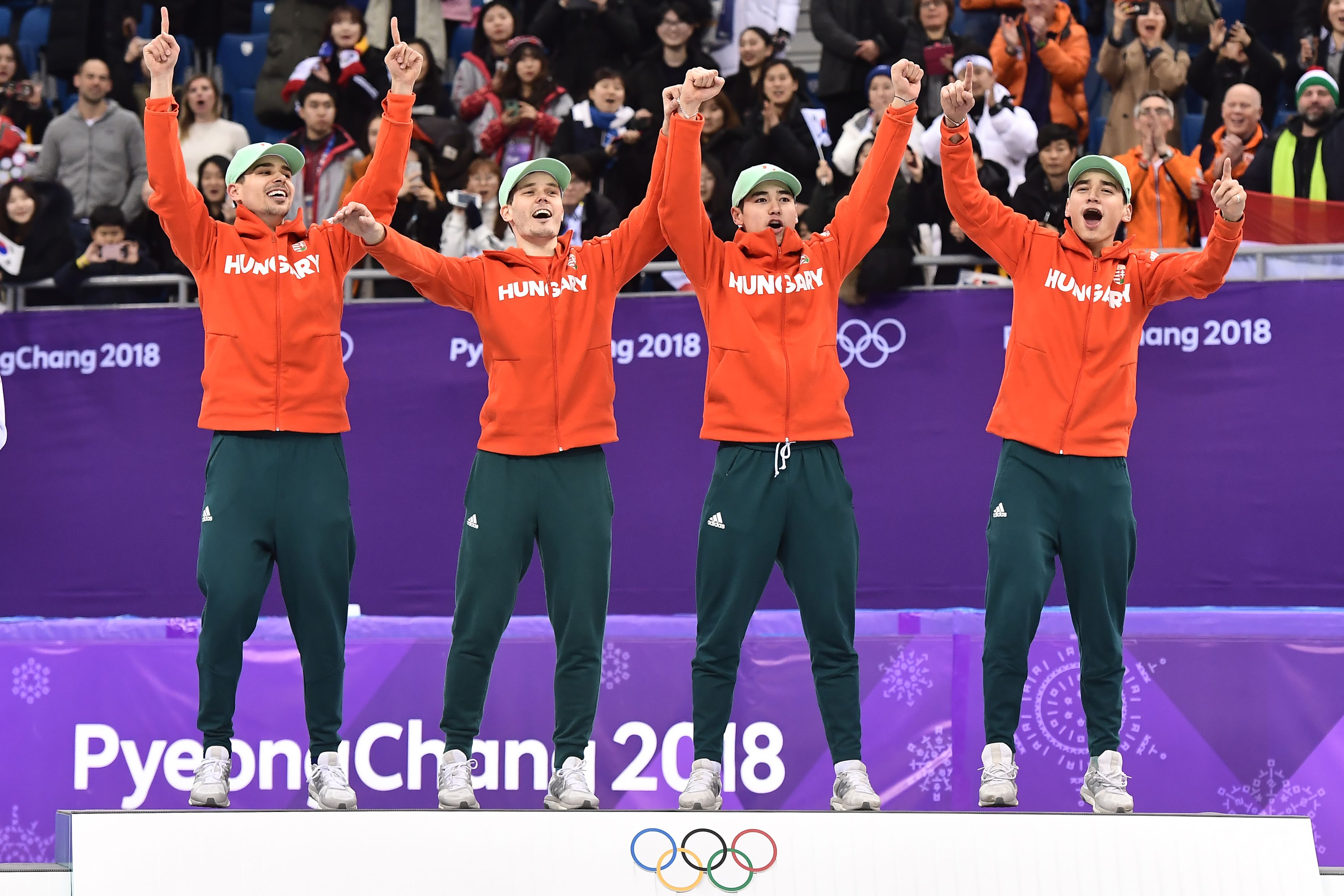 Team Hungary celebrate their gold win on the podium in the men's 5,000m relay short track speed skating on Feb. 22, 2018. (Aris Messinis—AFP/Getty Images)