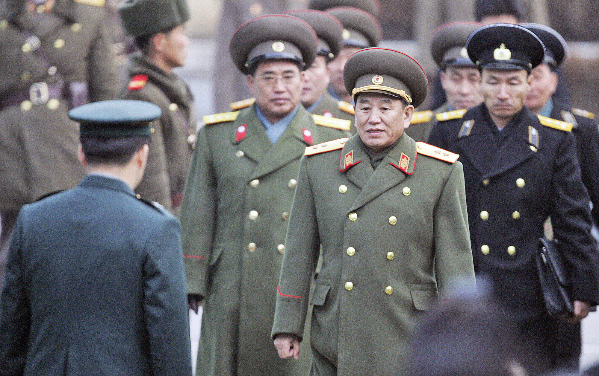 North Korean chief delegate Kim Yong Chol (2nd-R) and other military officers are greeted by South Korean officers after crossing the border line at the south side of the truce village of Panmunjom, in the demilitarized zone (DMZ)  on Dec. 12 2007. (LEE JIN-MAN—AFP/Getty Images)