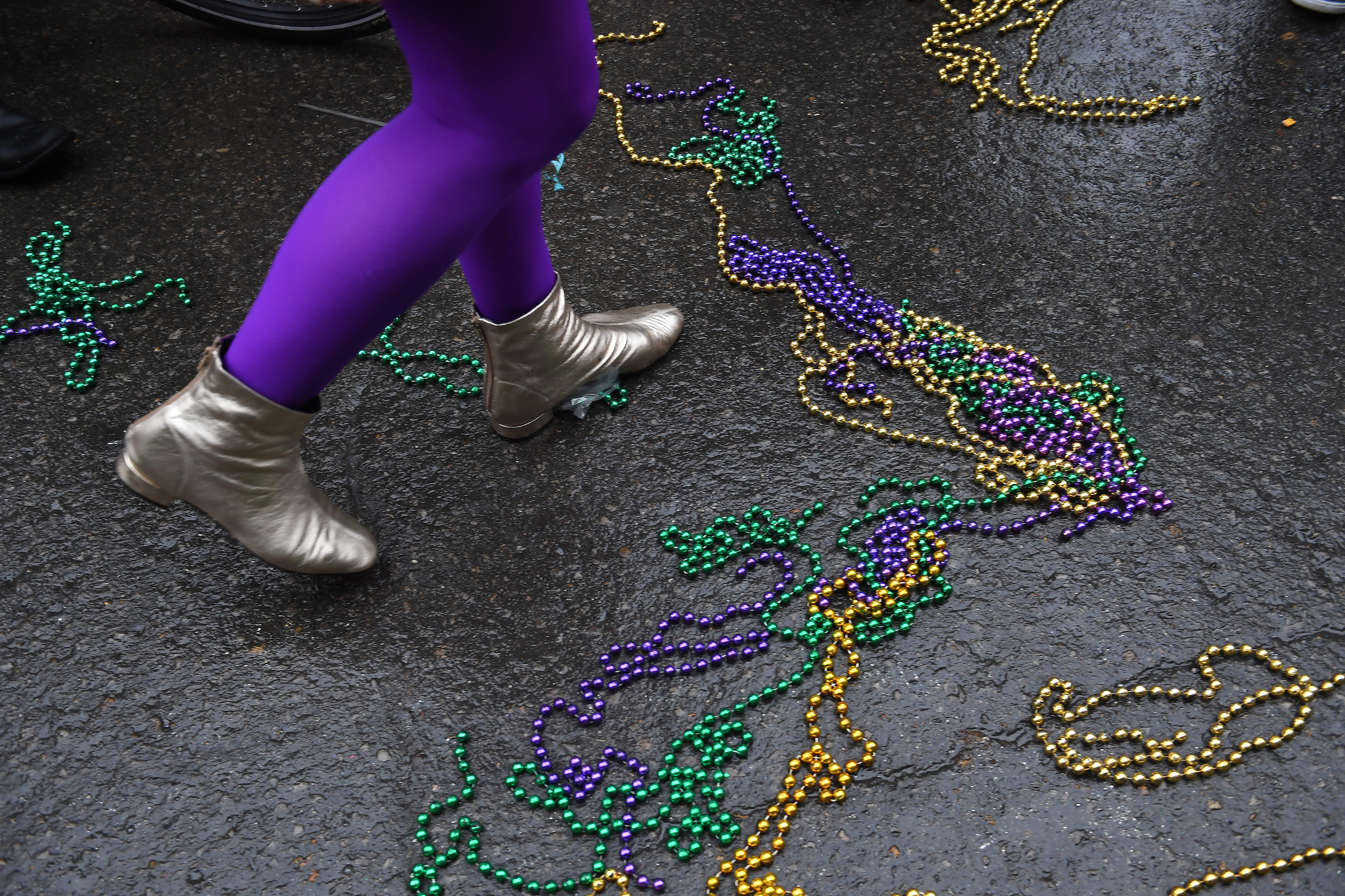 A person walks among beads during a parade on Feb. 17, 2017, in New Orleans. (The Washington Post / Getty Images)