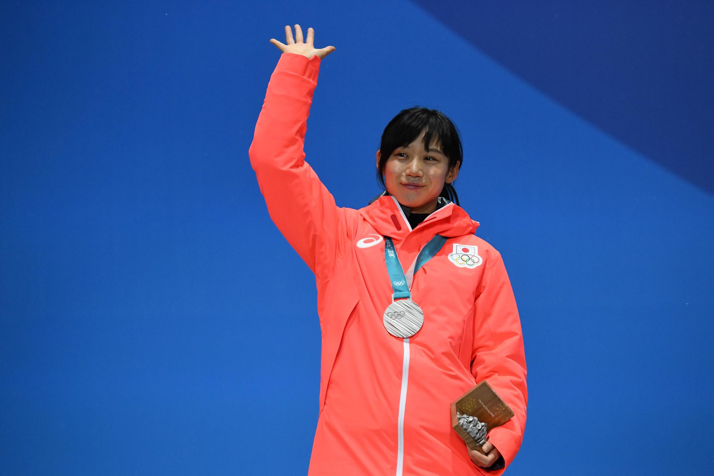 Japan's silver medallist Miho Takagi waves on the podium during the medal ceremony for the speed skating women's 1500m on Feb. 13, 2018.