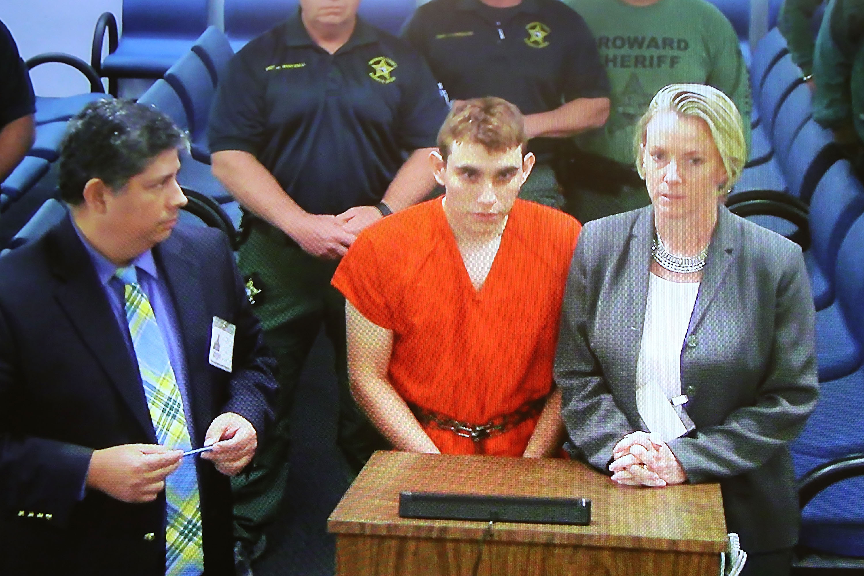 Nikolas Cruz, 19, a former student at Marjory Stoneman Douglas High School in Parkland, Florida, where he allegedly killed 17 people, is seen on a closed circuit television screen during a bond  hearing in front of Broward Judge Kim Mollica at the Broward County Courthouse on February 15, 2018 in Fort Lauderdale, Florida. Mr. Cruz is possibly facing 17 counts of premeditated murder in the school shooting. (Photo by Susan Stocker—Pool/Getty Images)