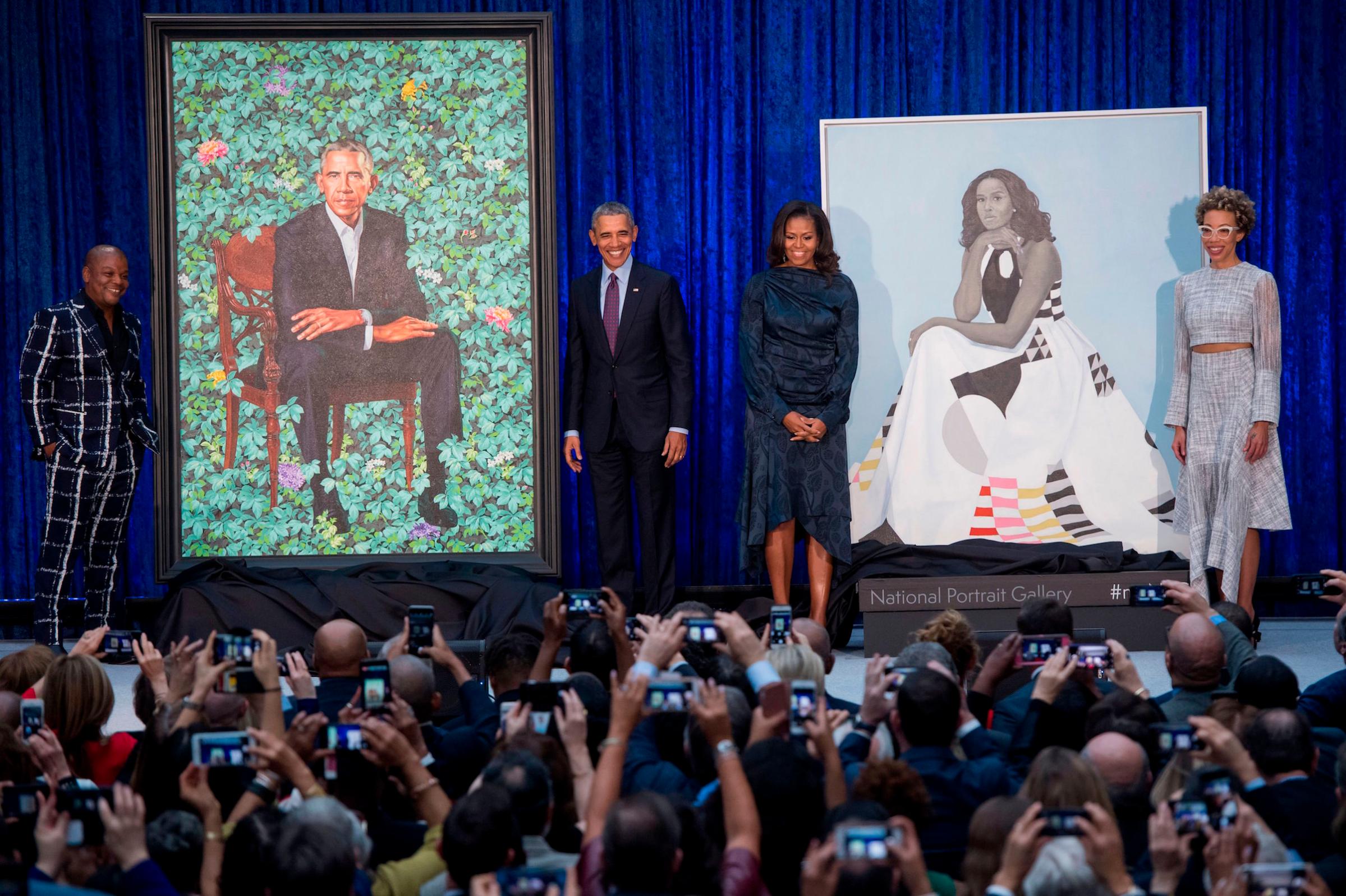 Barack and Michelle Obama with portraits by Kehinde Wiley and Amy Sherald