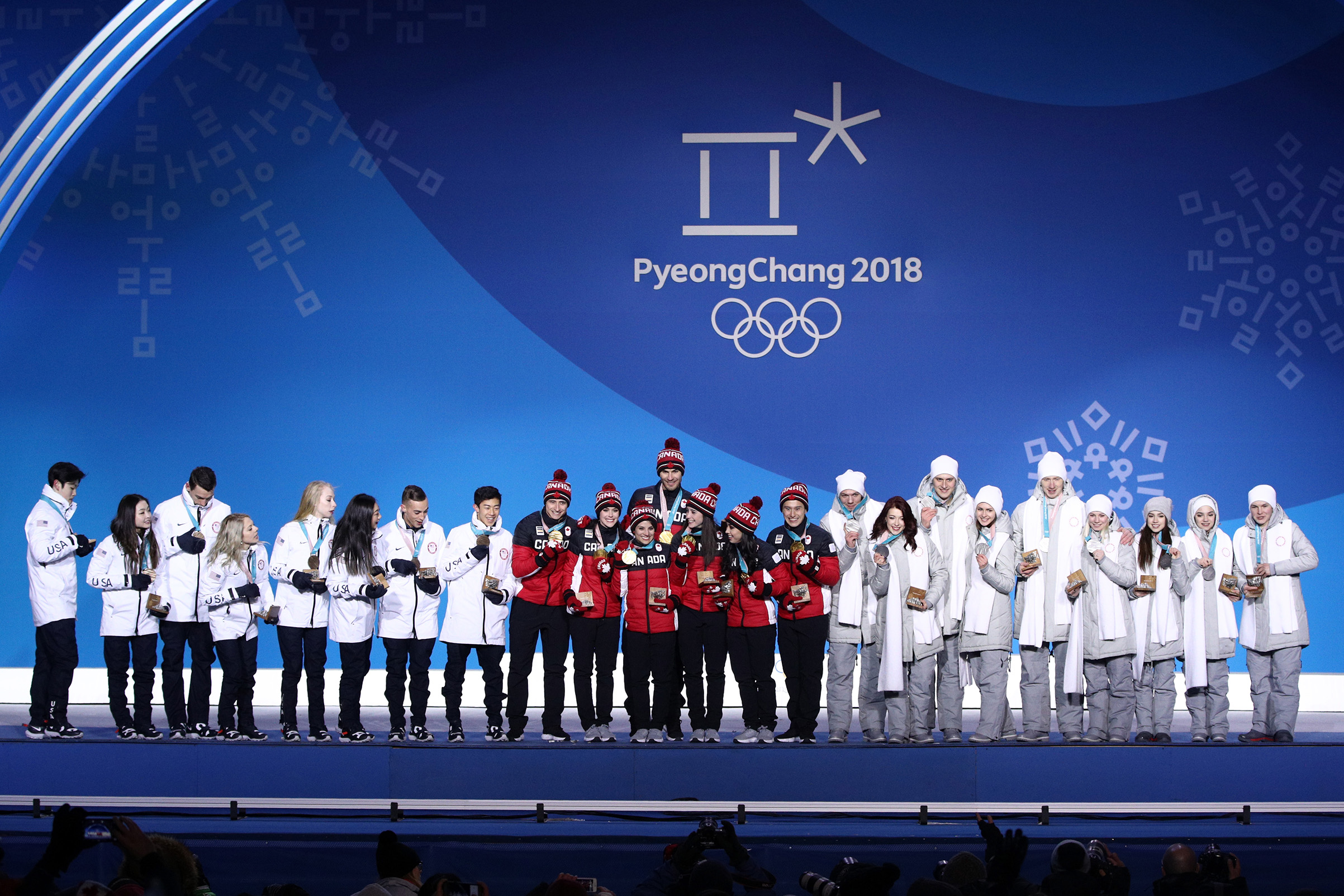 Silver medalists Team Olympic Athlete from Russia, gold medalists Team Canada and bronze medalists Team United States celebrate during the medal ceremony after the Figure Skating Team Event at Medal Plaza on Feb. 12, 2018 in Pyeongchang-gun, South Korea. (Adam Pretty—Getty Images)