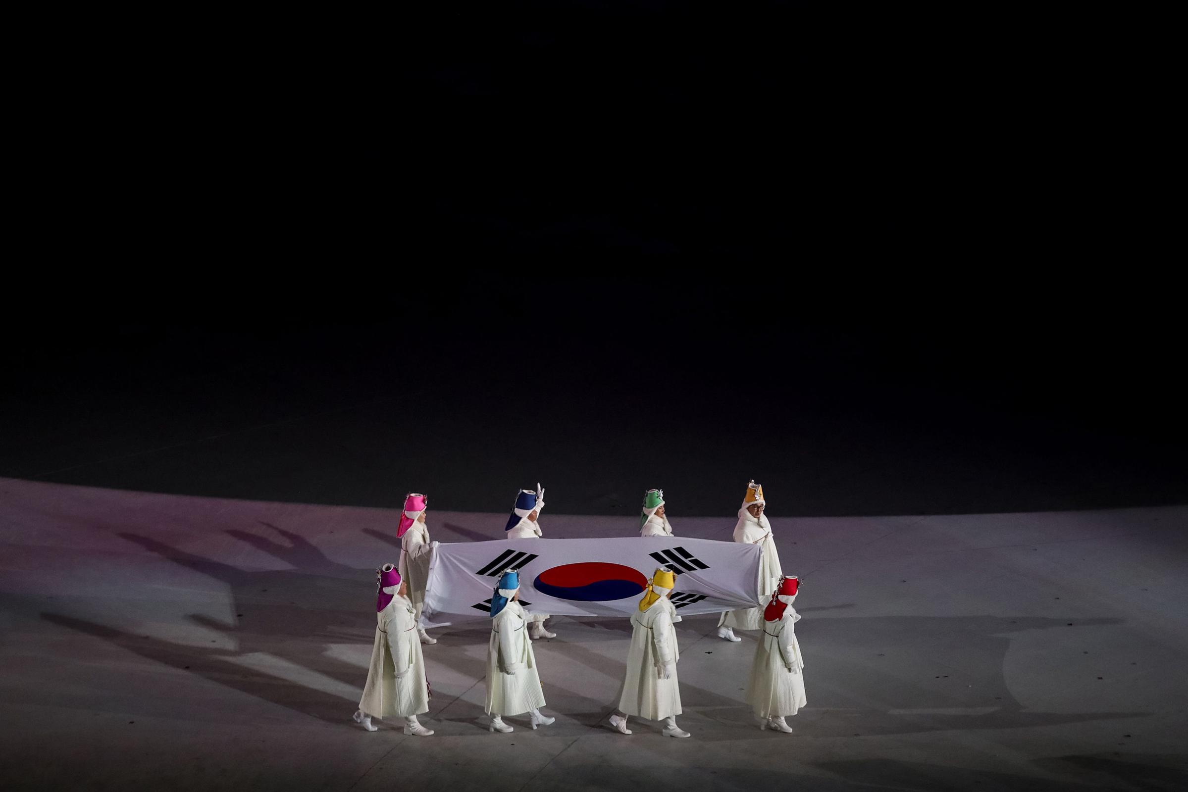 Former South Korean Olympians carry the South Korean flag during the opening ceremony of the Pyeongchang 2018 Winter Olympic Games.