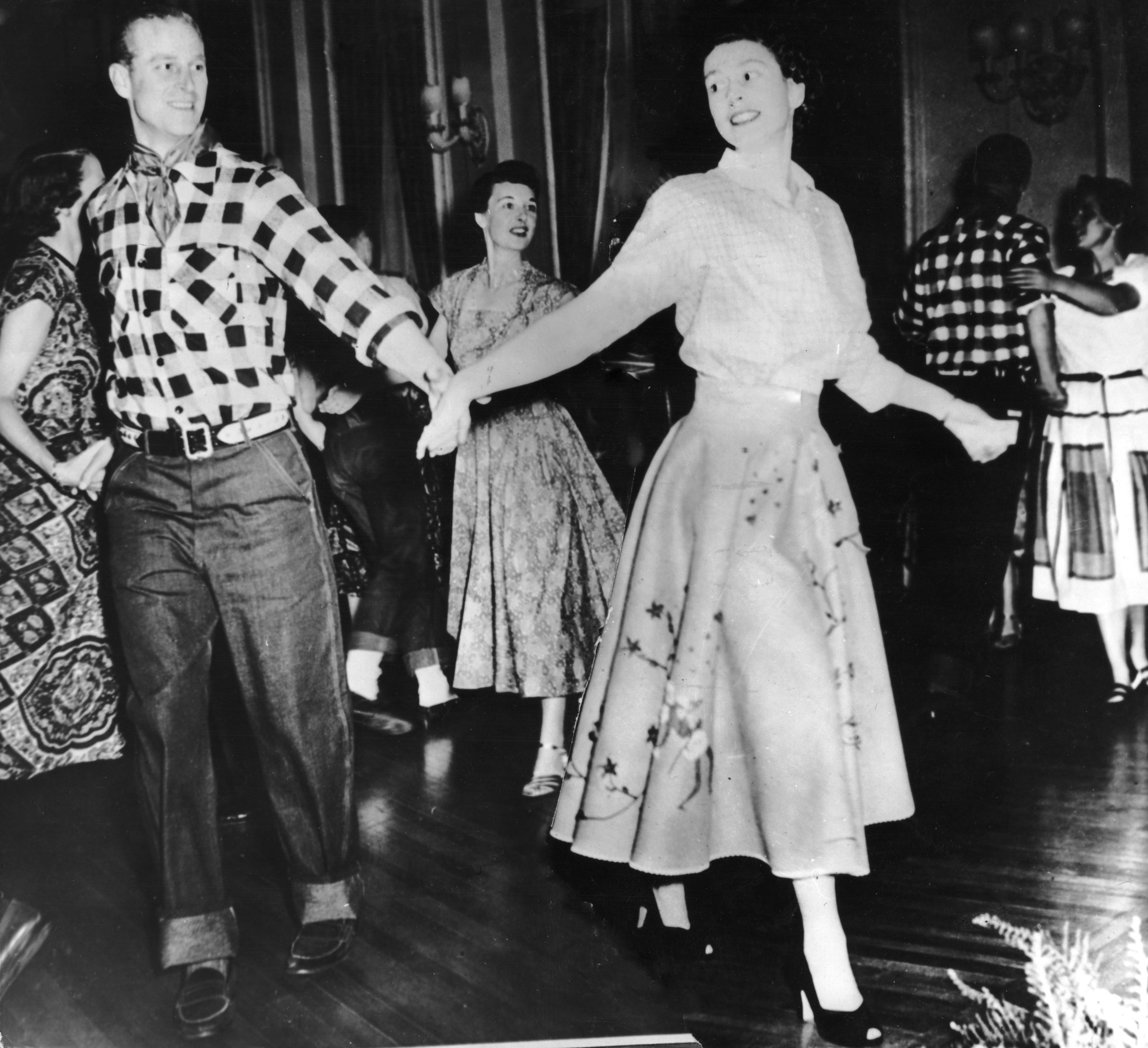 The Duke of Edinburgh dances with his wife, Princess Elizabeth, at a square dance held in their honour in Ottawa, by Governor General Viscount Alexander, Oct. 17, 1951. The dance was one of the events arranged during their Canadian tour. (Keystone/Hulton Archive—Getty Images)