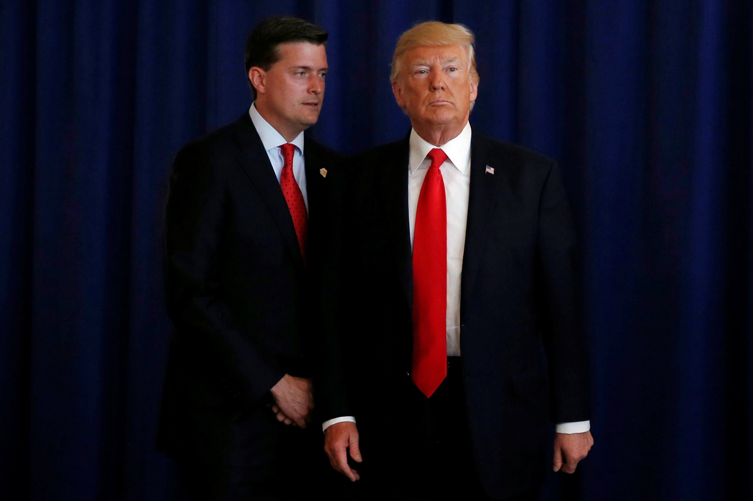 White House Staff Secretary Rob Porter speaks to President Donald Trump at his golf estate in Bedminster, New Jersey, Aug. 12, 2017. (Jonathan Ernst—Reuters)