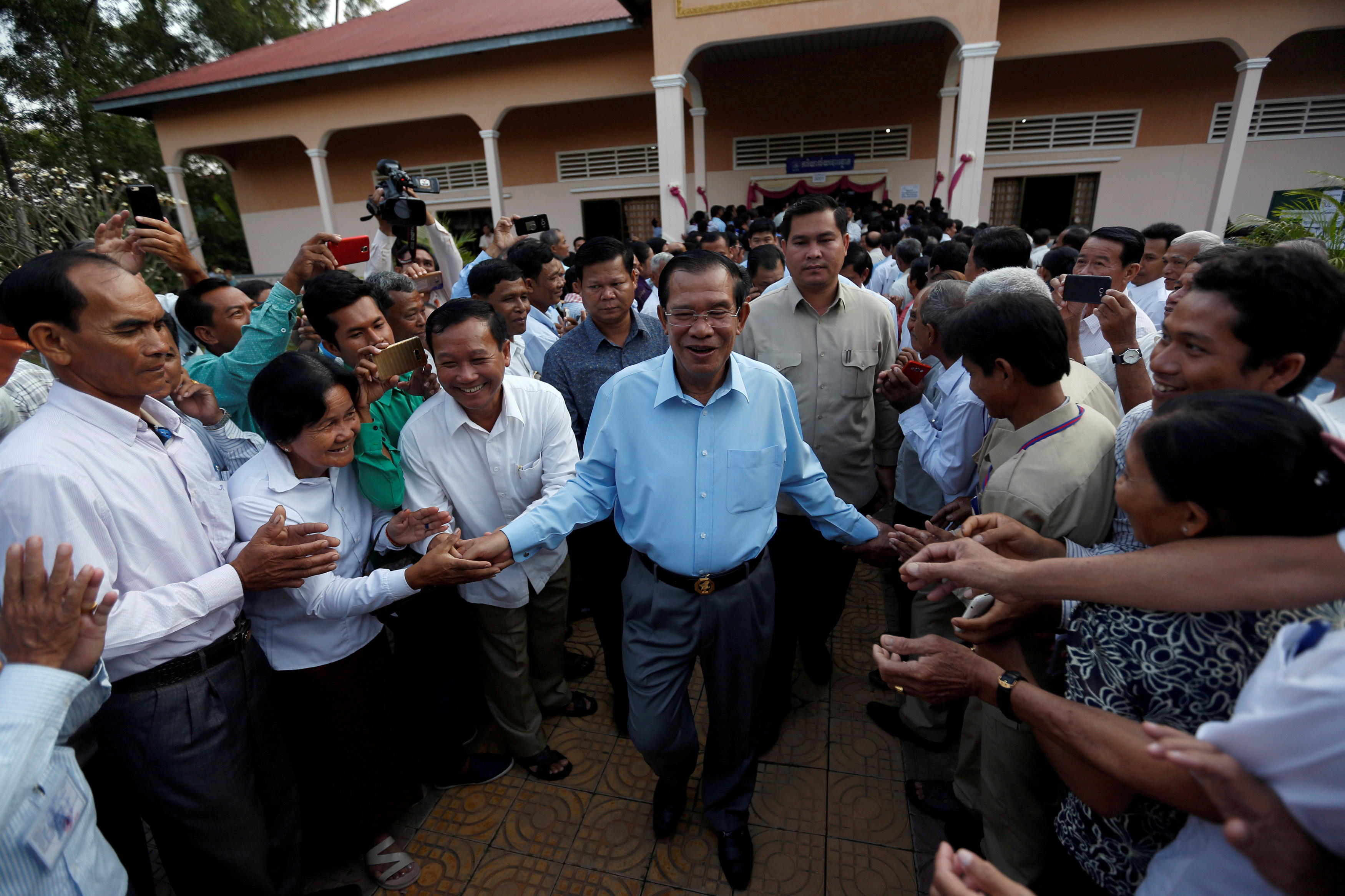 Cambodia's Prime Minister Hun Sen surrounded by commune counselors during at a Senate election polling station in Takhmao, Kandal province, Cambodia on Feb. 25, 2018. (Pring Samrang—Reuters)